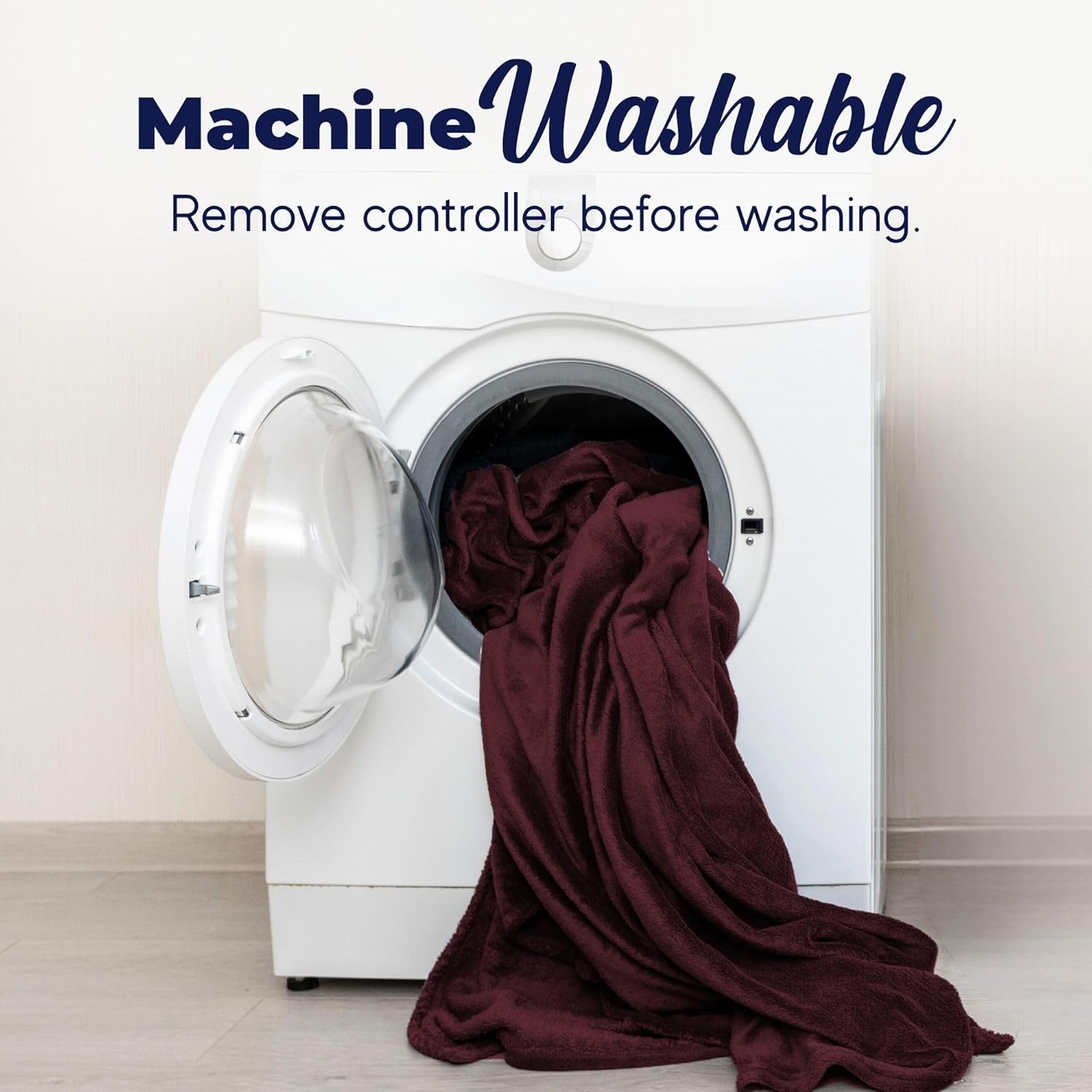 A burgundy Dreamaker heated blanket being placed into a front-loading washing machine.