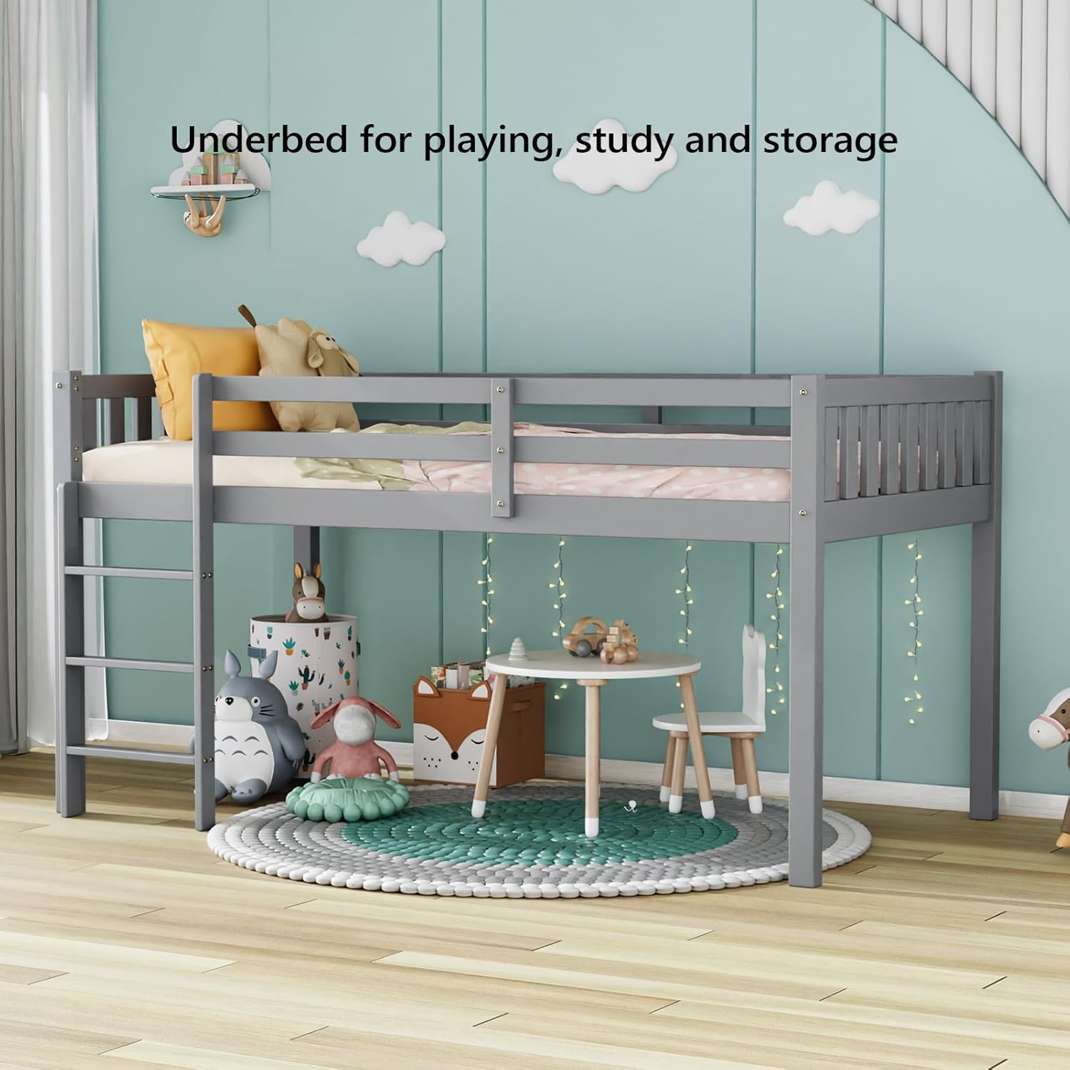 Low loft bed with a small table and chairs underneath, used as a study or play area
