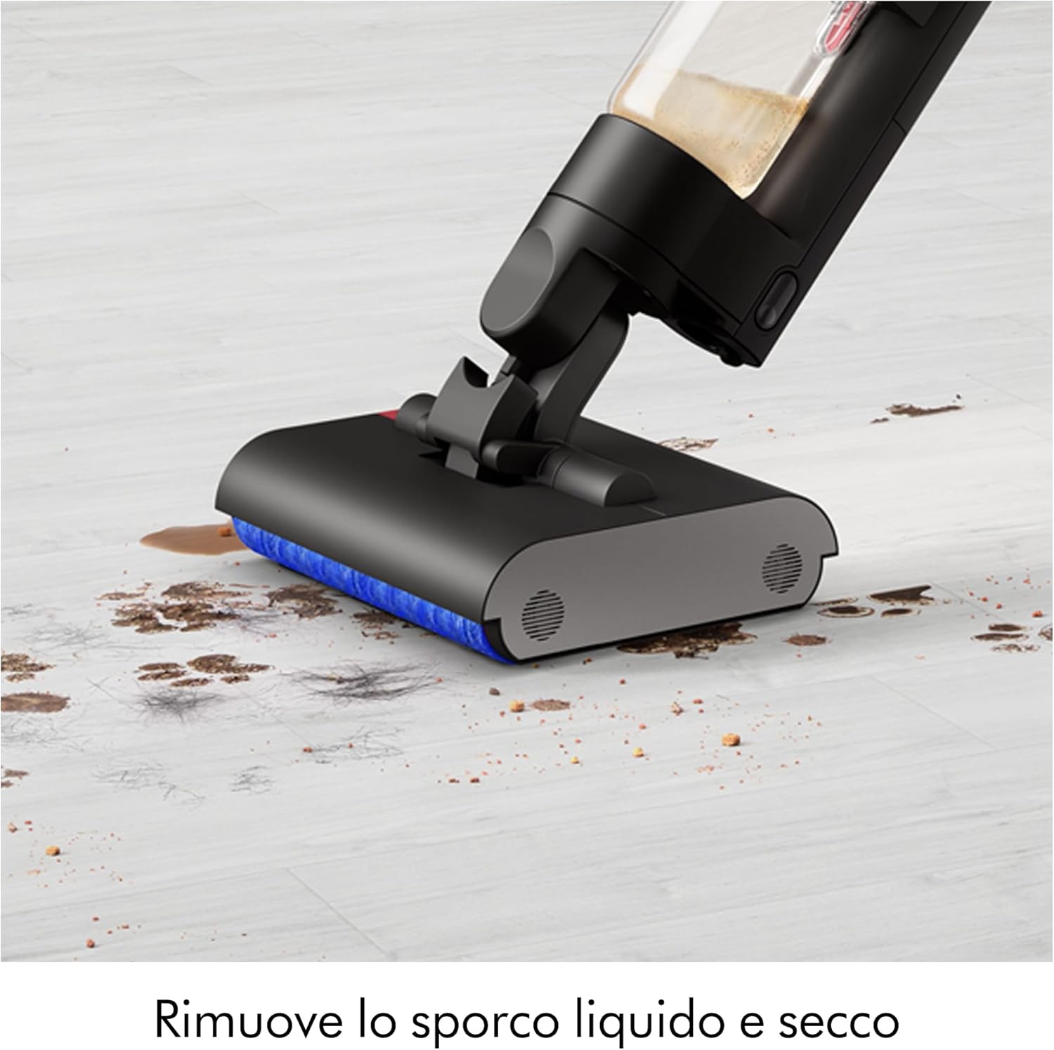 Close-up of Dyson WashG1 head cleaning wet and dry mess on a light floor.