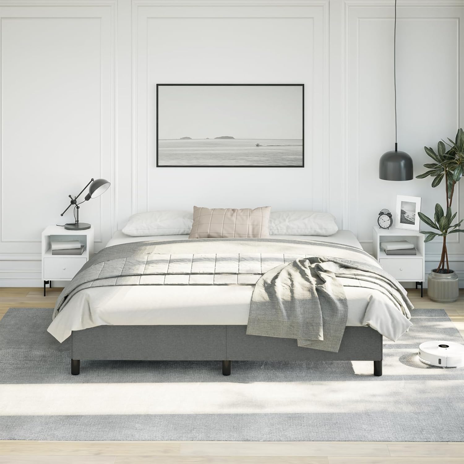 A modern bedroom featuring the dark gray King size bed frame with a mattress and bedding, without a headboard.