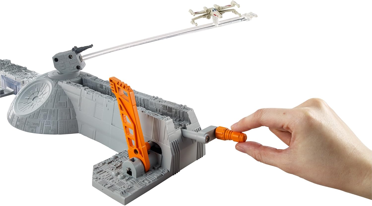 Hand operating the launch mechanism of the play set