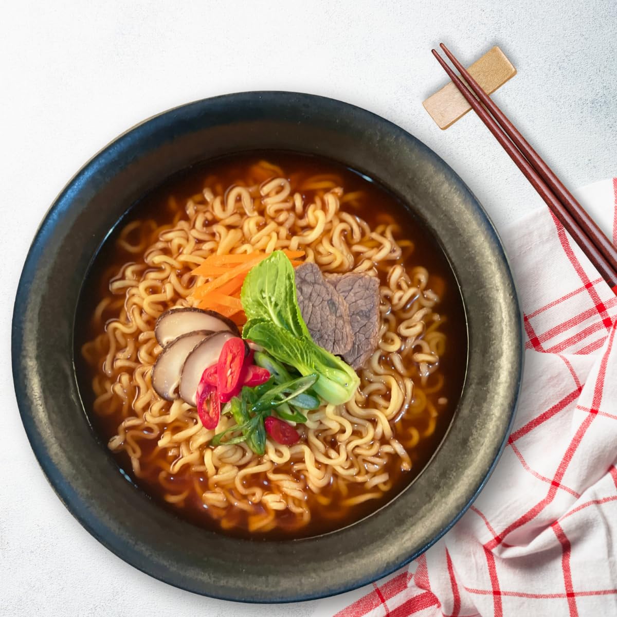 Korean instant ramen with thick noodles and a spicy, savoury broth. The Han Kitchen Pocha Ramyun — Premium pocha-style noodles, ready in 5 minutes.118 g (Pack of 4) (SPICY)