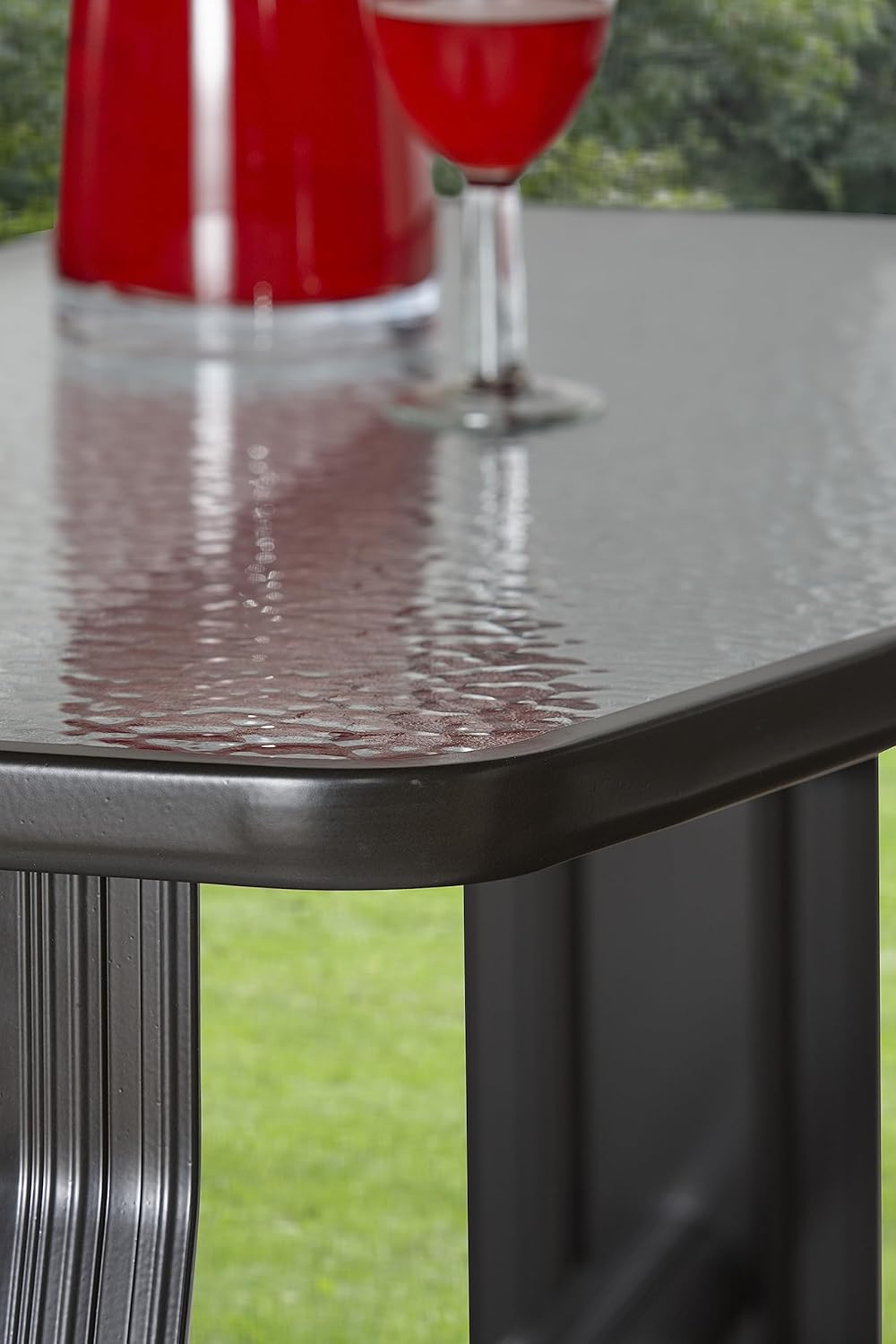 Close-up of the tempered glass table on the garden swing