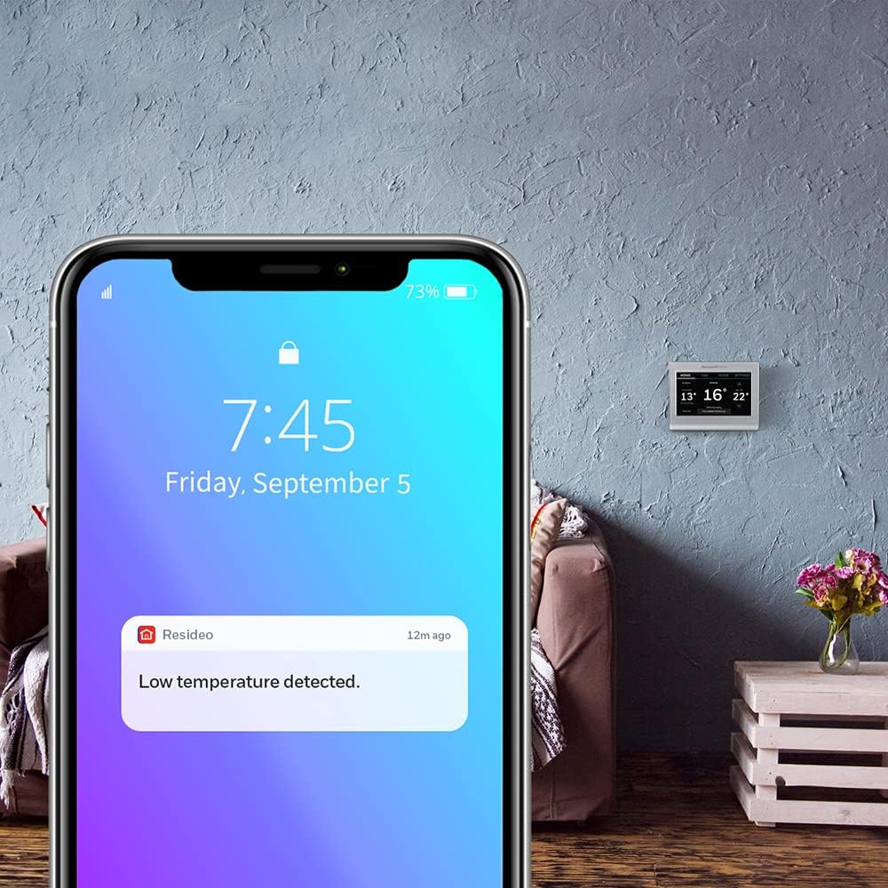 Honeywell Home RTH9585WF thermostat on a wall with 'Works with Alexa' and 'Works with Hey Google' logos, indicating smart home compatibility.