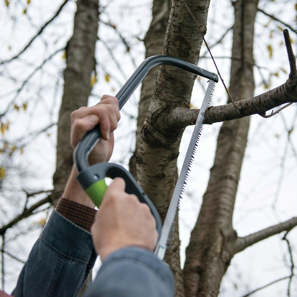 Person using Silverline 250422 Bow Saw to cut a tree branch