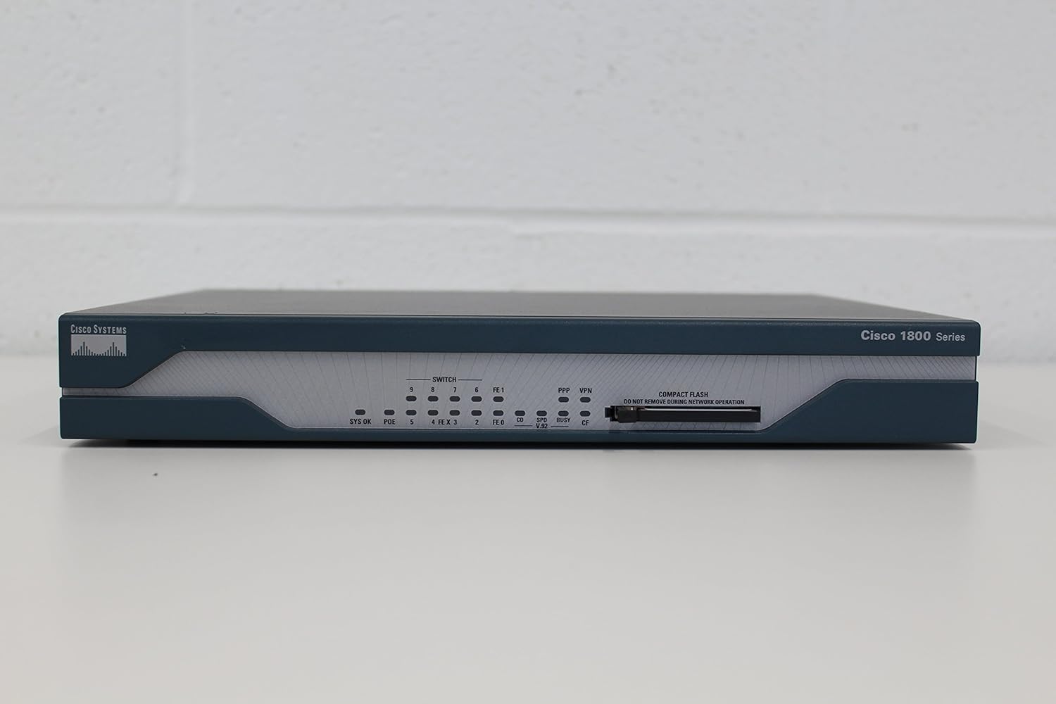 ഫ്രണ്ട് view of the Cisco CISCO1811/K9 router showing LED indicators and Compact Flash slot