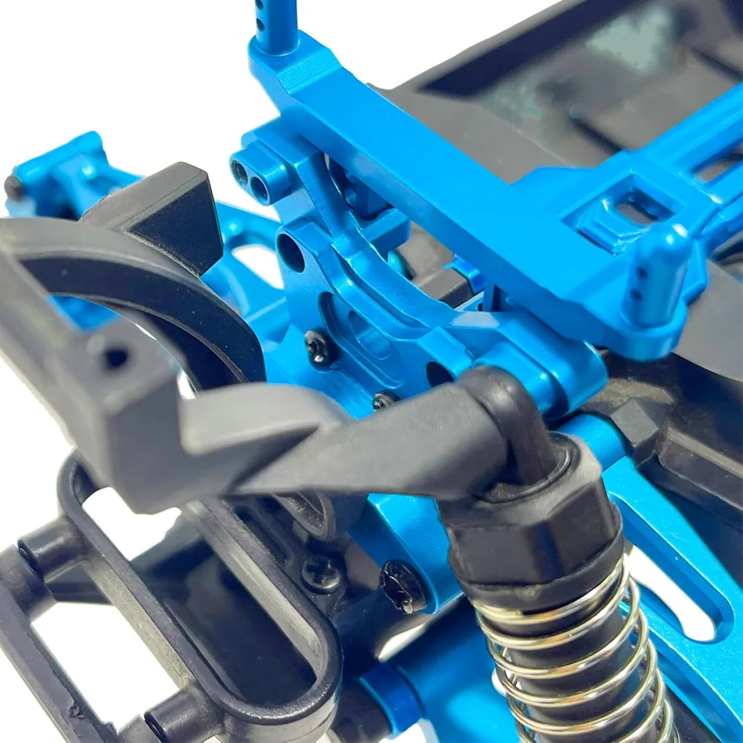 Close-up of a blue metal rear shock bracket installed on an RC car chassis