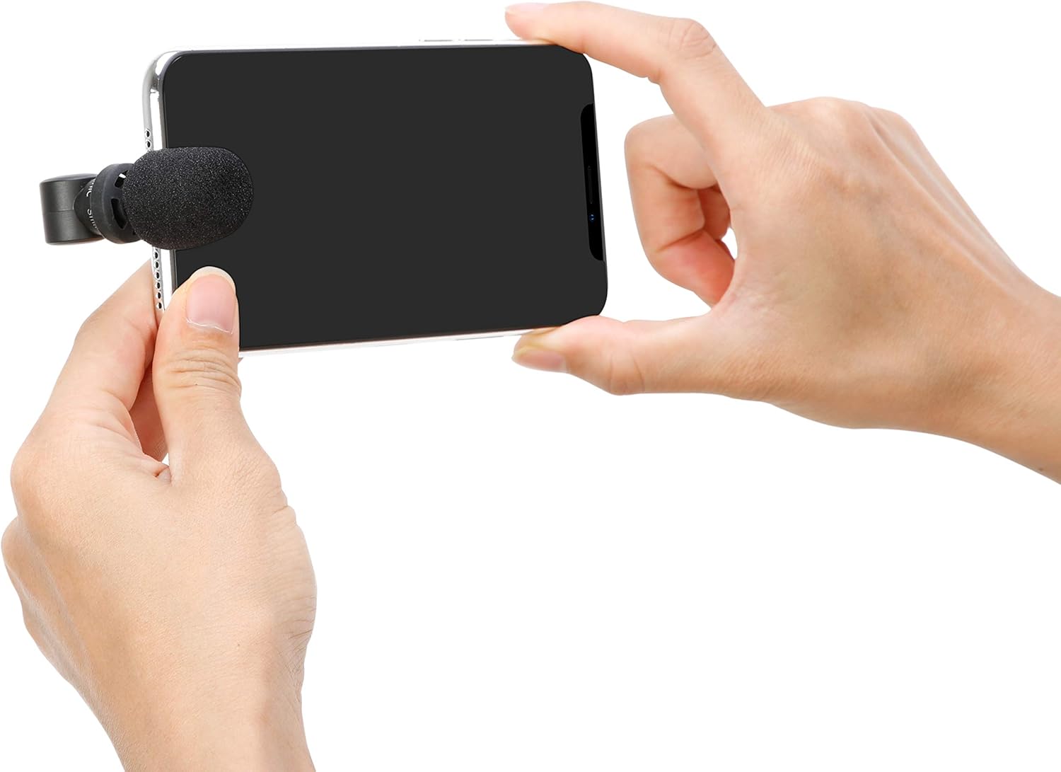 User holding an iPhone with the Saramonic SmartMic Di Mini attached, ready for recording