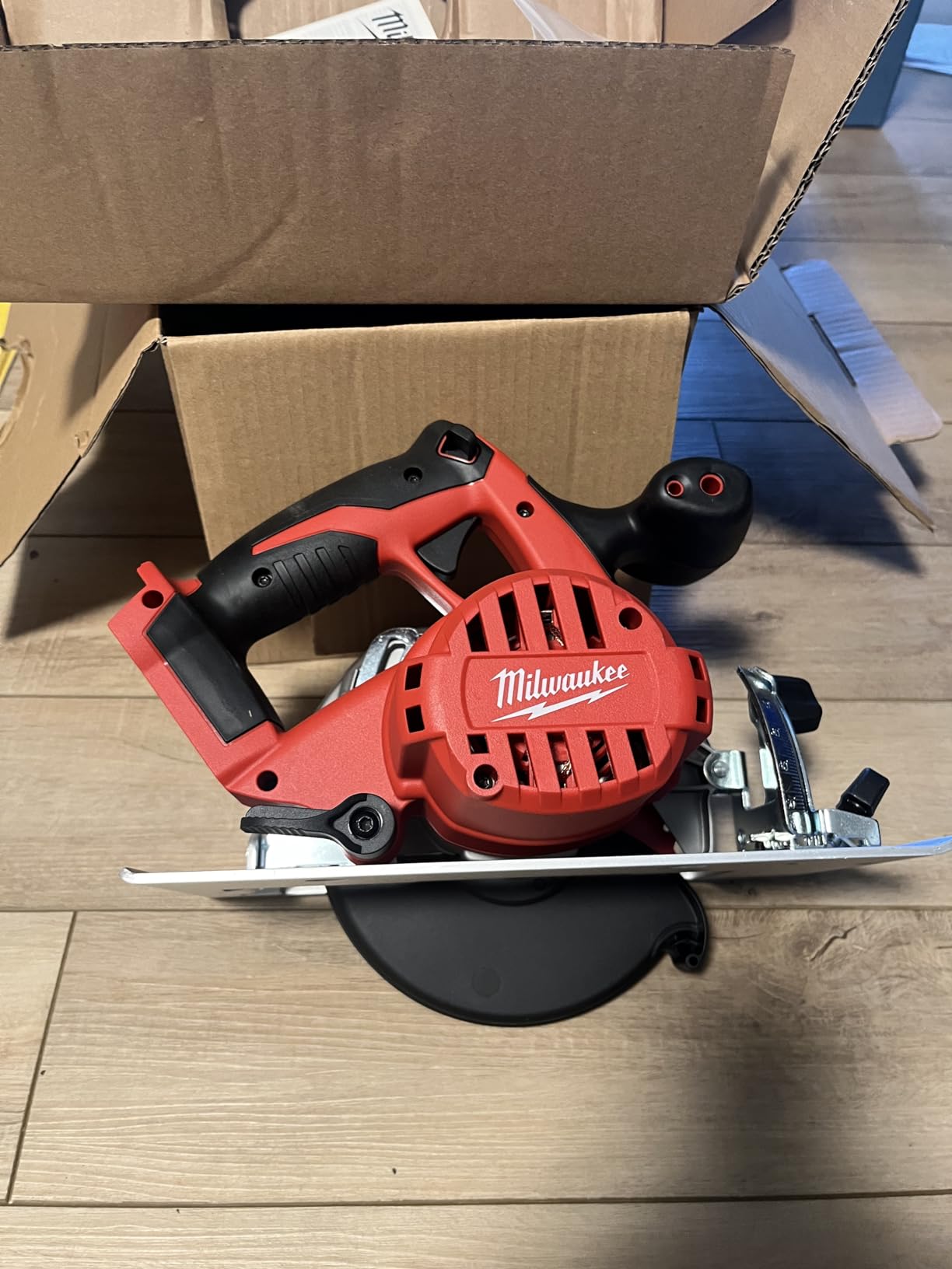 Milwaukee circular saw cutting through lumber on a jobsite