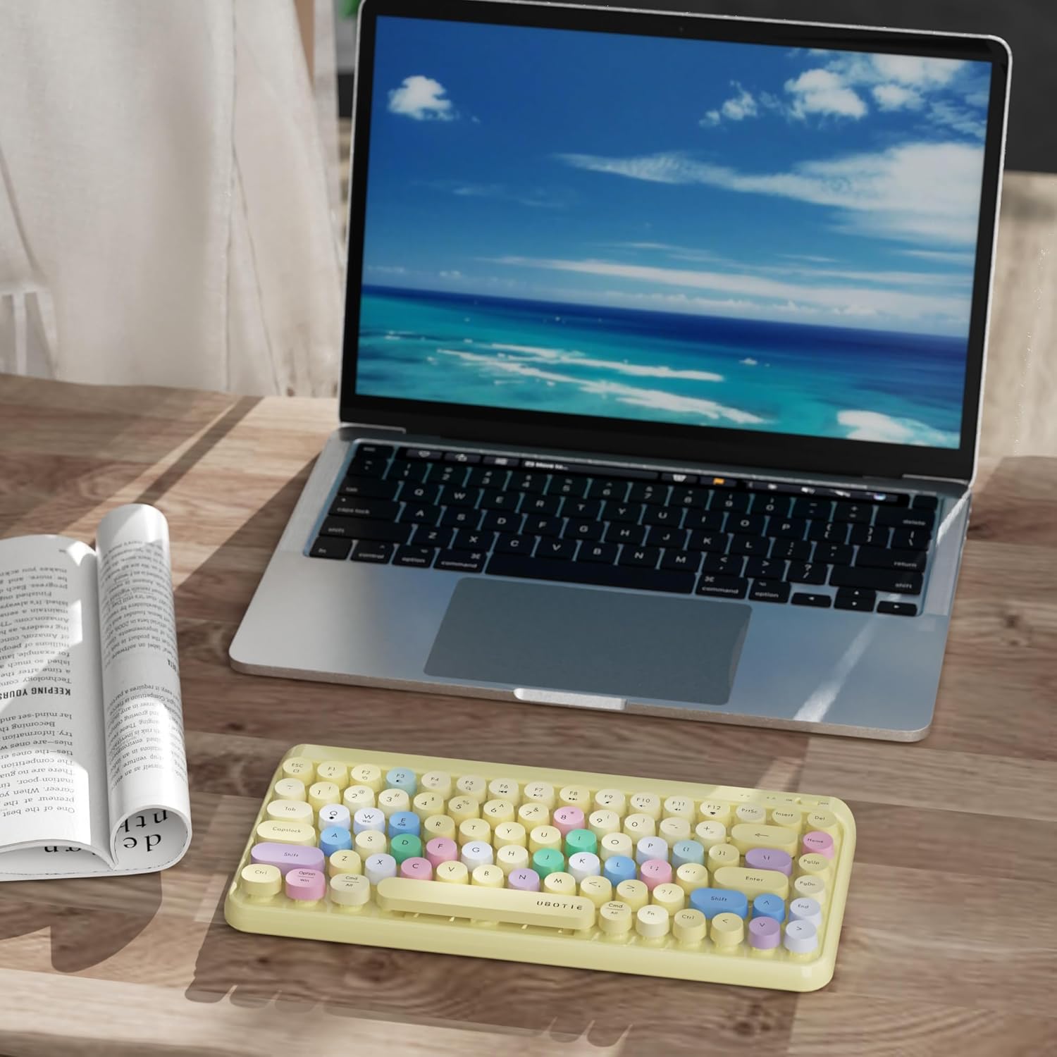 Close-up of the UBOTIE keyboard with some keycaps removed, showing the underlying switches