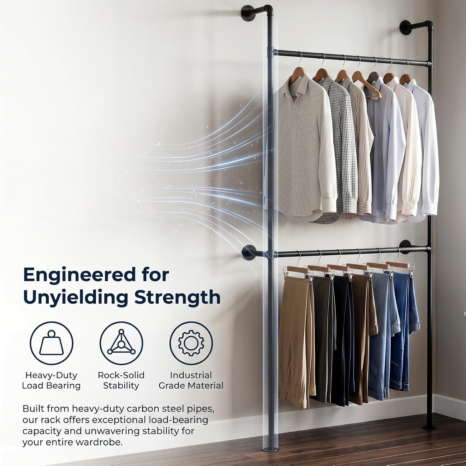 A wall-mounted industrial pipe clothes rack with two rods, holding shirts on the top rod and pants on the bottom rod, demonstrating its strength and capacity.