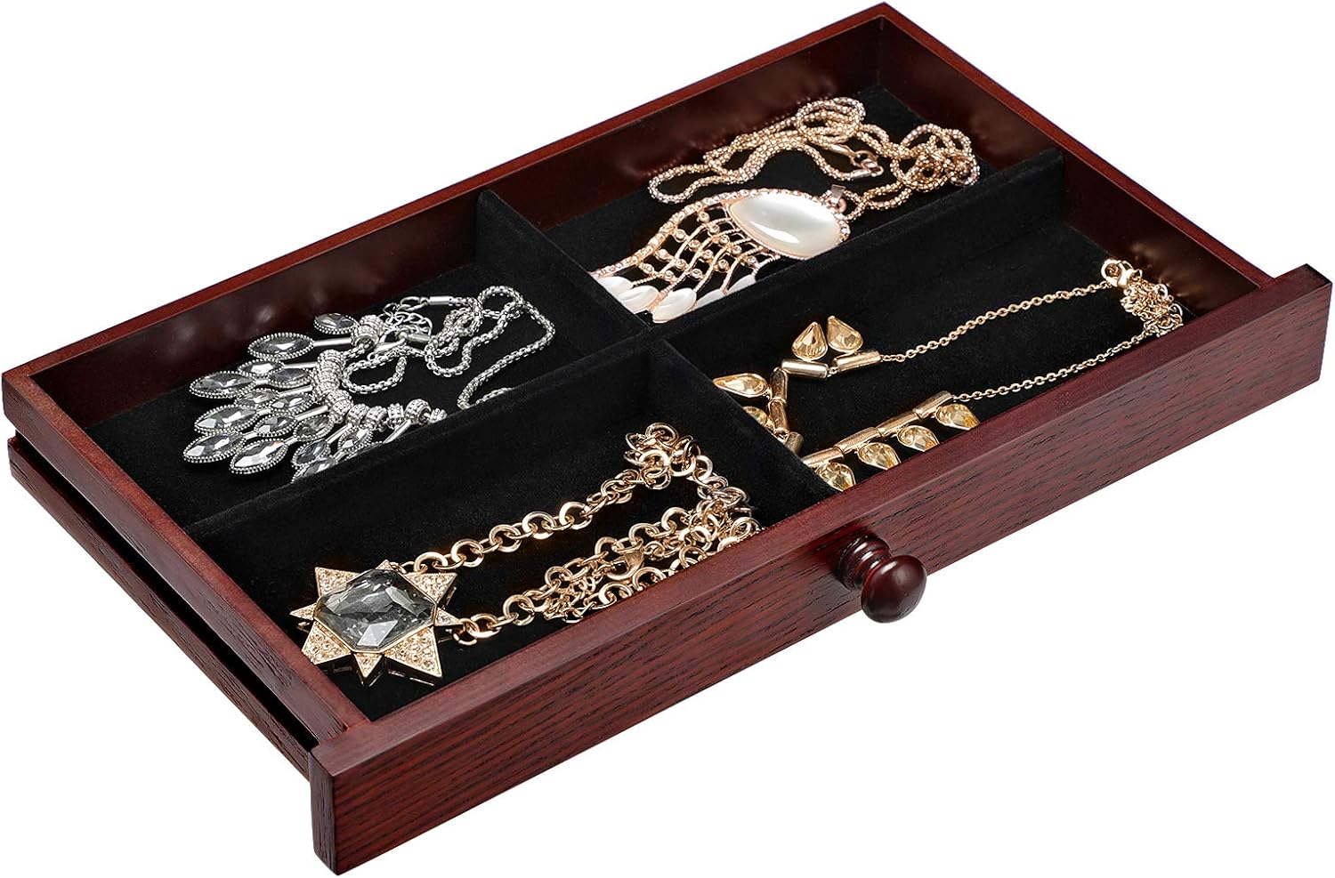 One of the pull-out drawers from the SONGMICS UJOW14BR jewelry box, showing divided compartments filled with necklaces and pendants.
