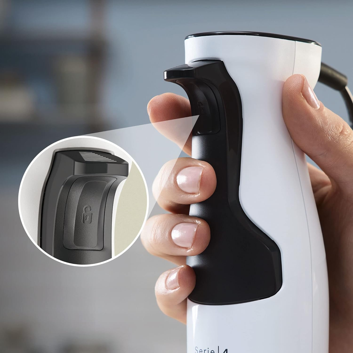 Close-up of the unlock button on the hand blender handle