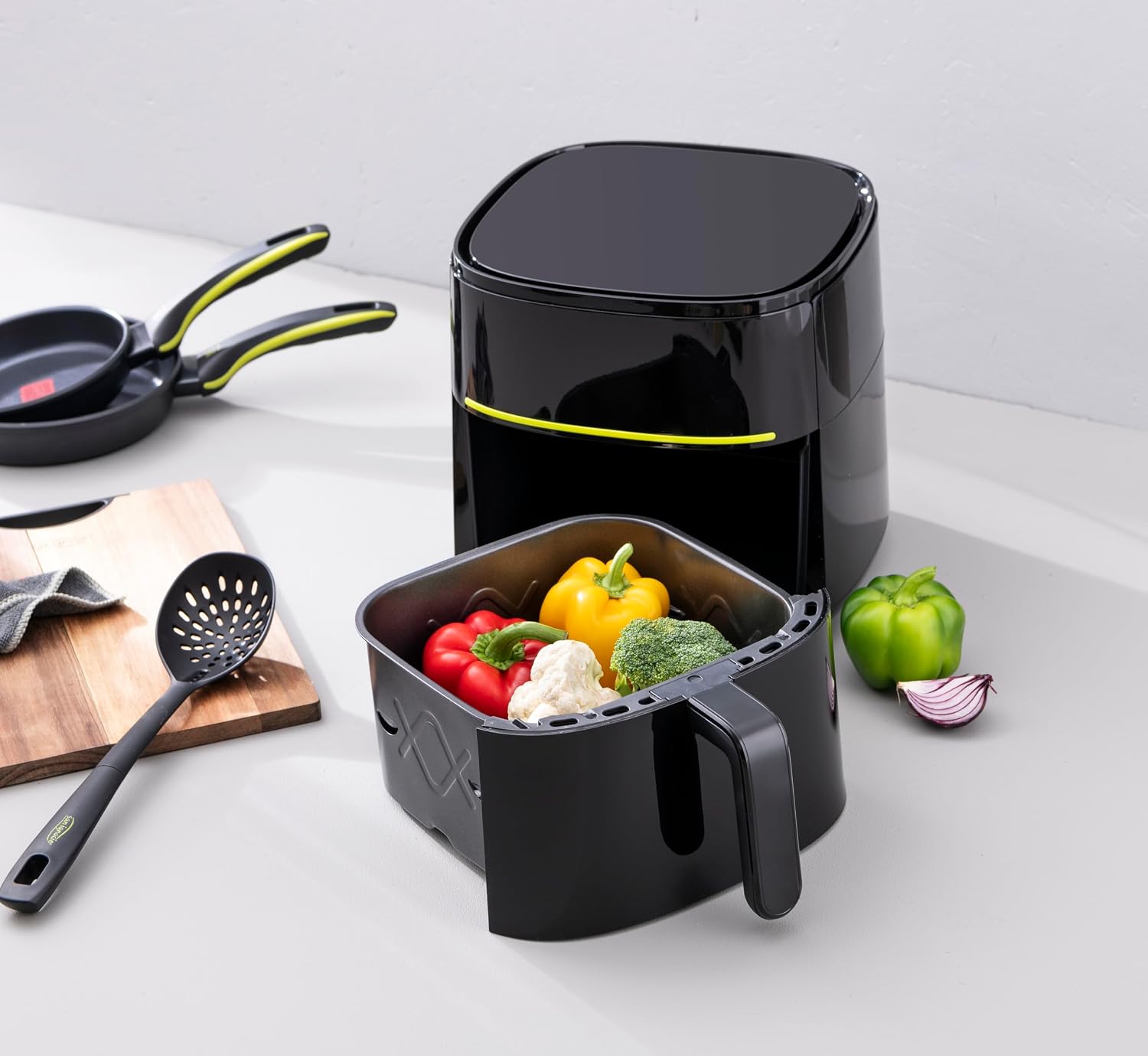 Air fryer basket filled with vegetables