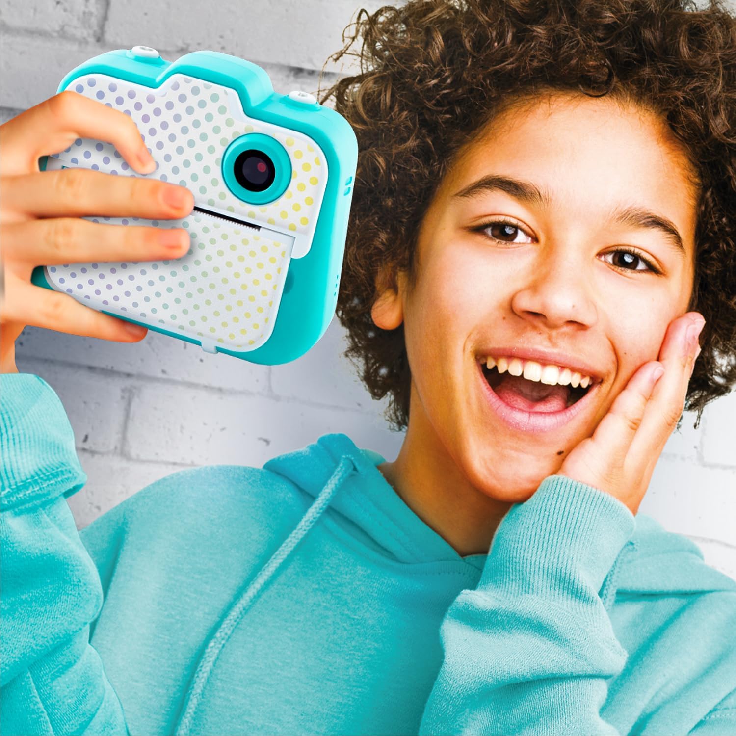 Child holding the Canal Toys Photo Creator CLK 001 camera to take a selfie
