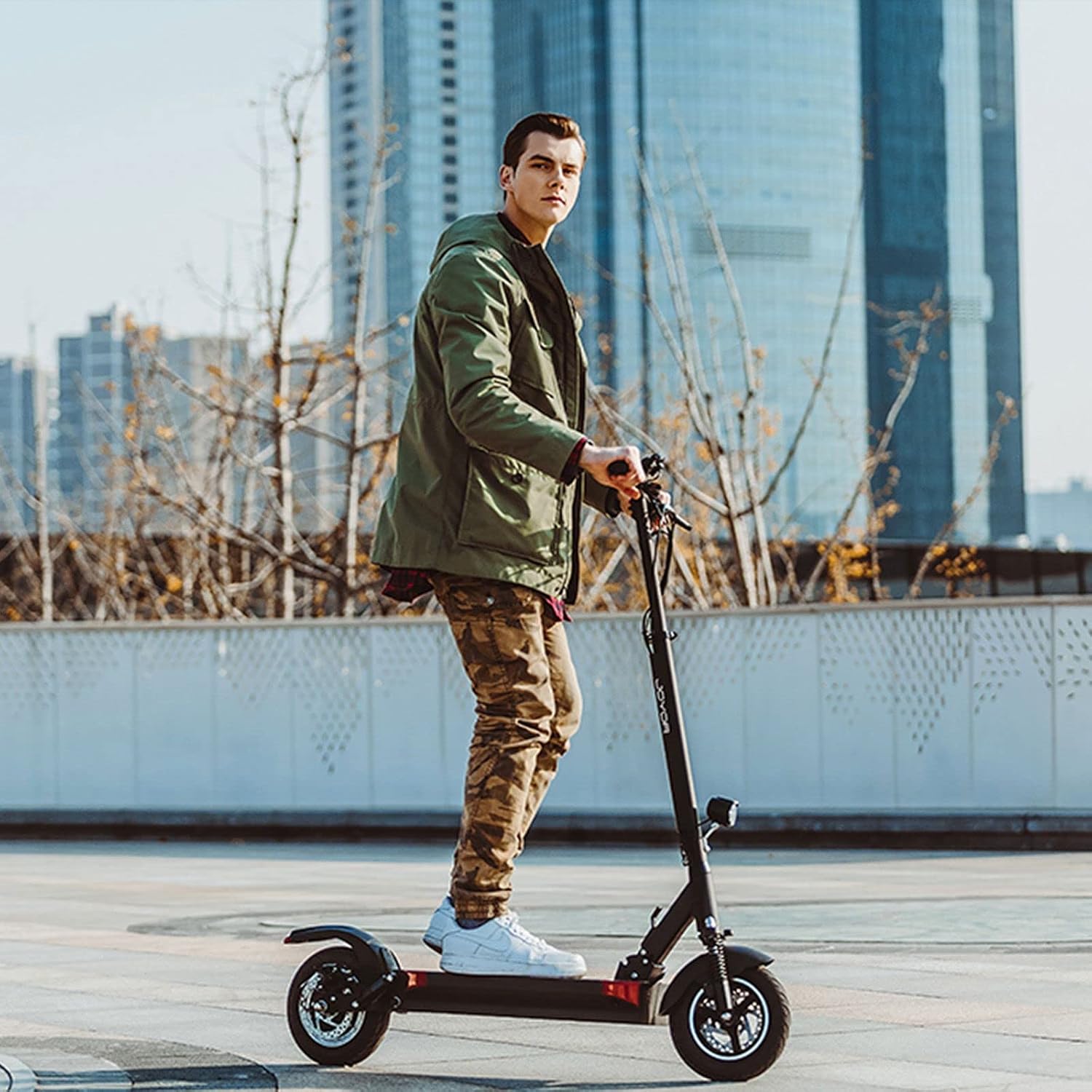 Man riding JOYOR Y6-S Electric Scooter on a paved surface