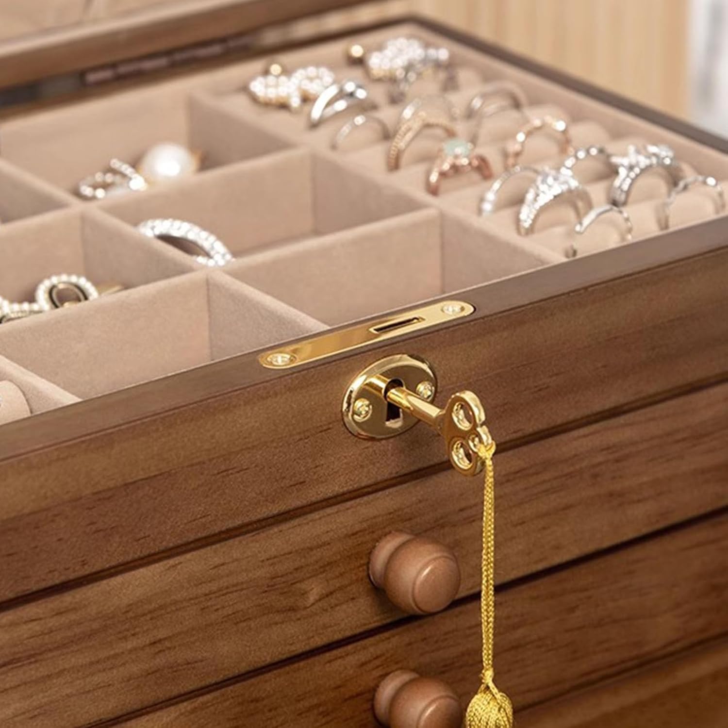 Close-up of the golden lock and key on the front of the TITISKIN jewelry box.