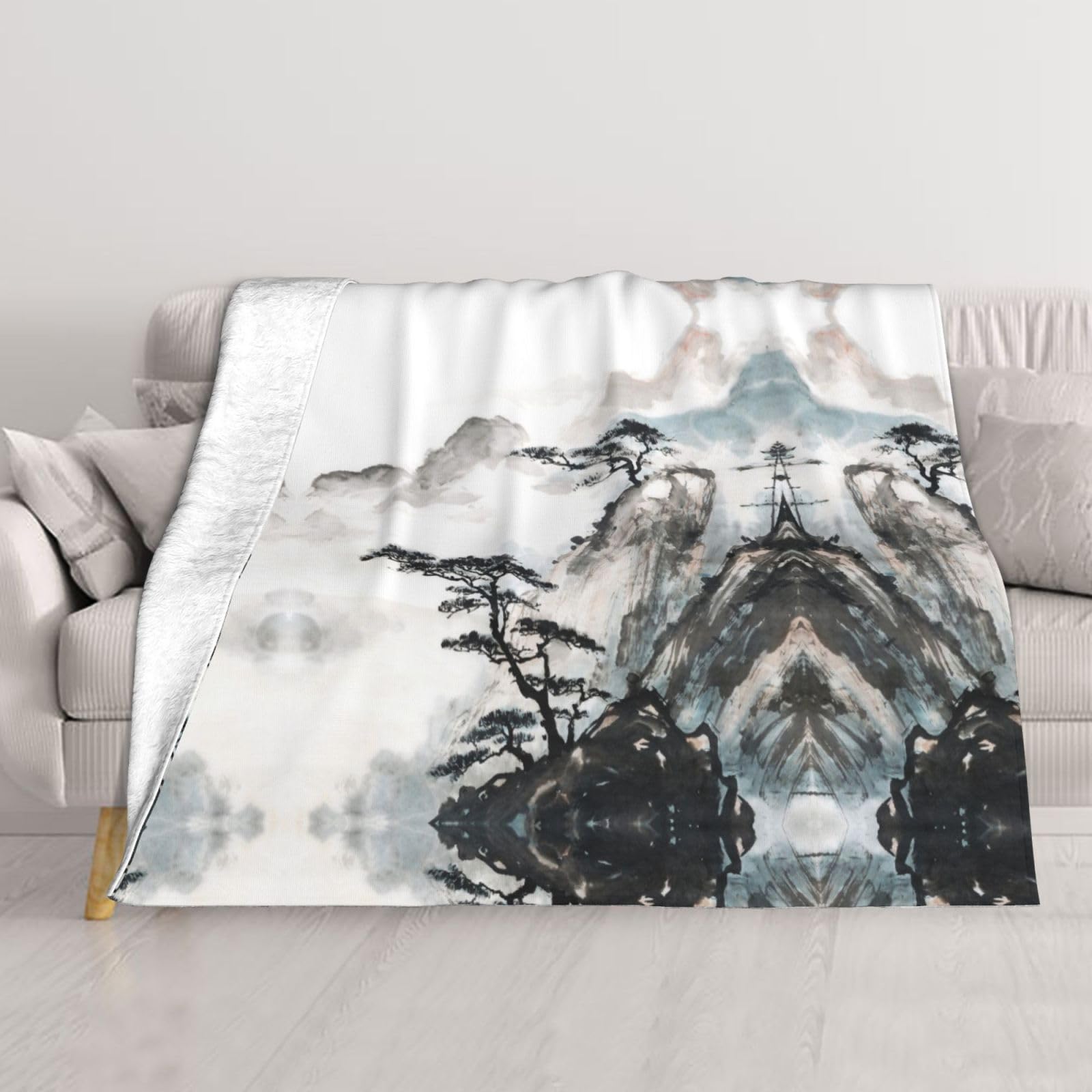 Couverture brumeuse imprimé pin pour vos soirées d'hiver cocooning au salon
