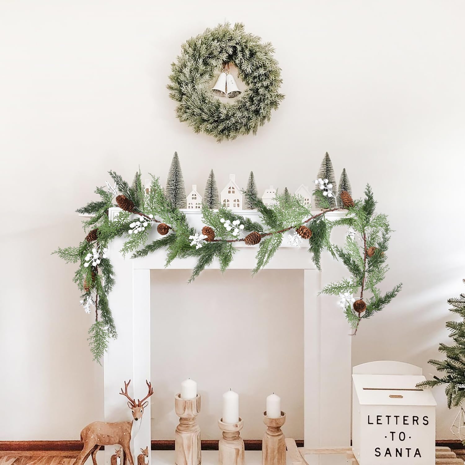 Shelf decorated with greenery and pinecones.