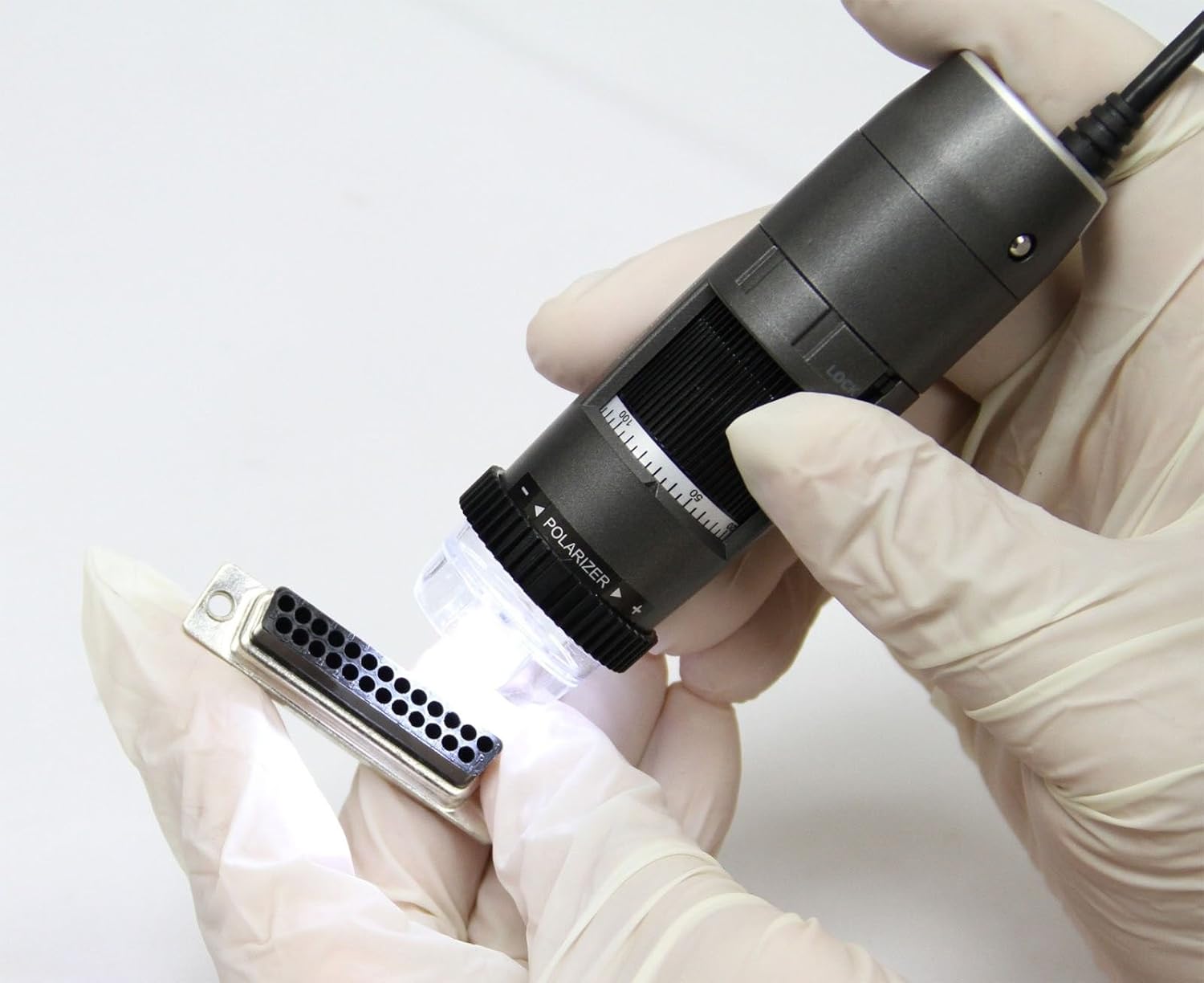 User holding Dino-Lite AM4815ZT to inspect a connector