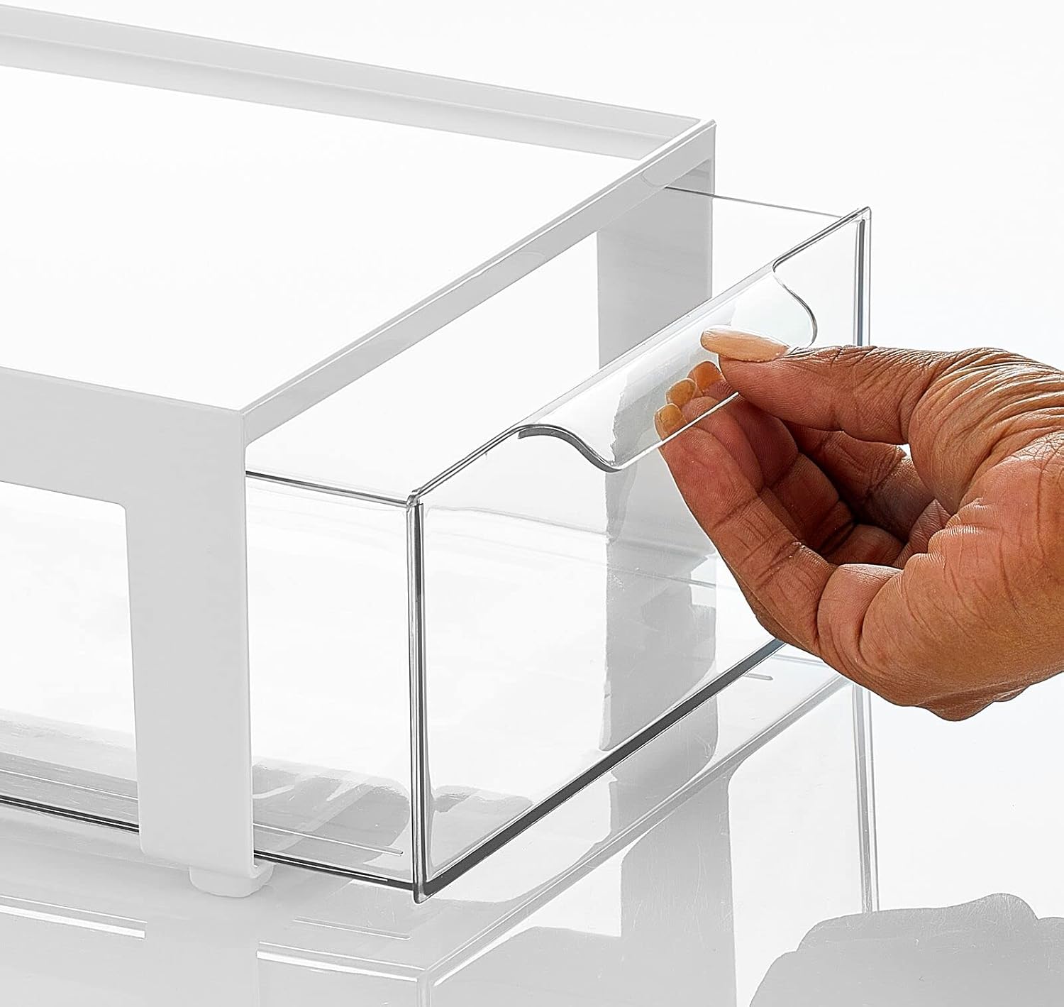 A hand pulling out a clear drawer from an mDesign storage bin, showing the ease of access.