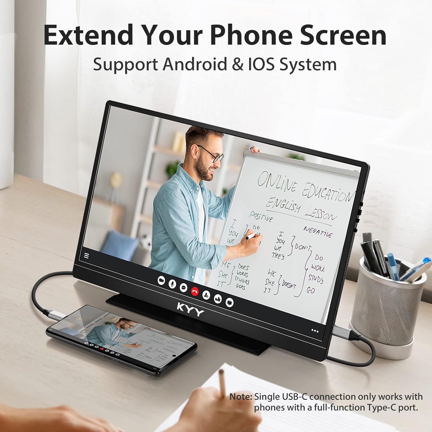 A KYY portable monitor displaying an online education lesson, connected to a smartphone via a single USB-C cable, with a person taking notes.