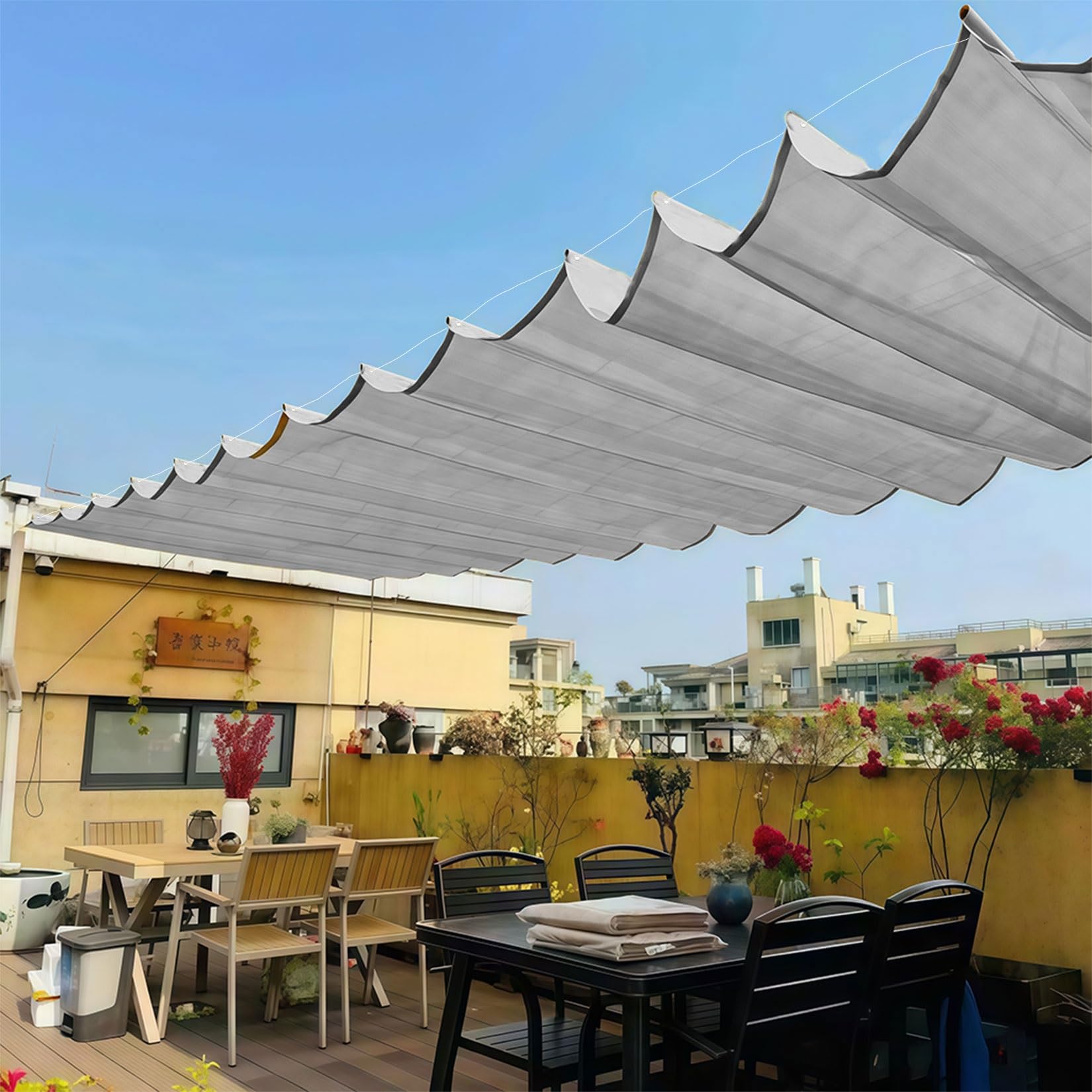 Toldo vela retráctil impermeable con protección UV y ojales para regular la sombra del jardín