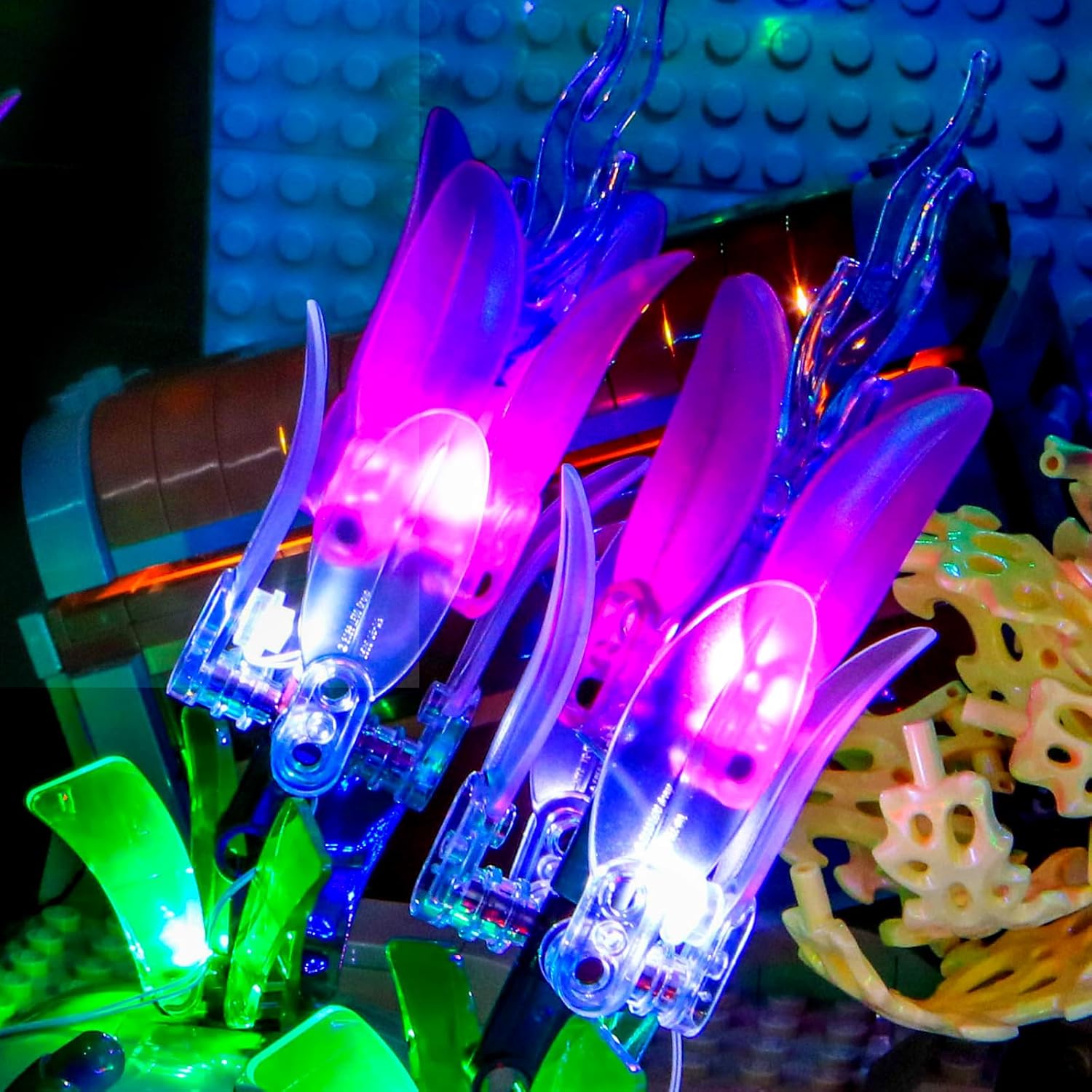 Close-up of purple and blue plant-like elements within the LEGO aquarium, illuminated by the LED kit.