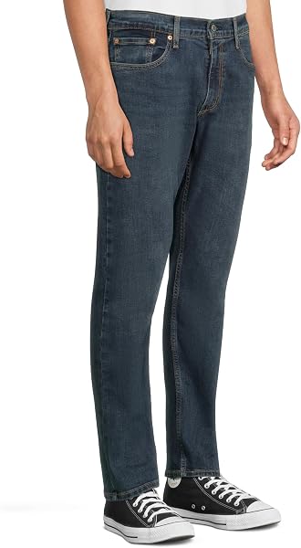 A close-up shot showcasing the modern taper of the Levi's 502 jeans from knee to ankle.