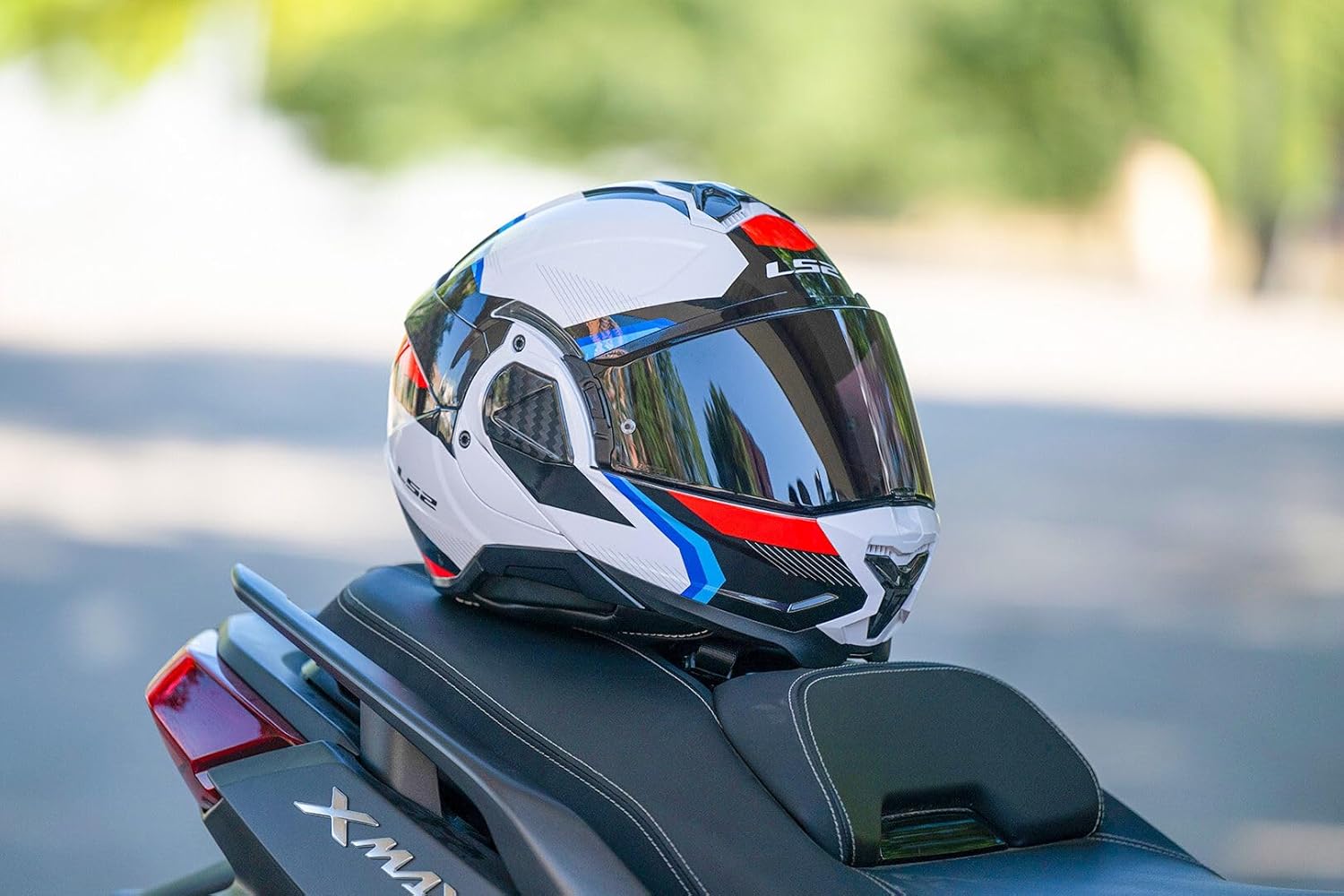 LS2 FF910 Advant II System Helmet with tinted visor resting on a motorcycle seat