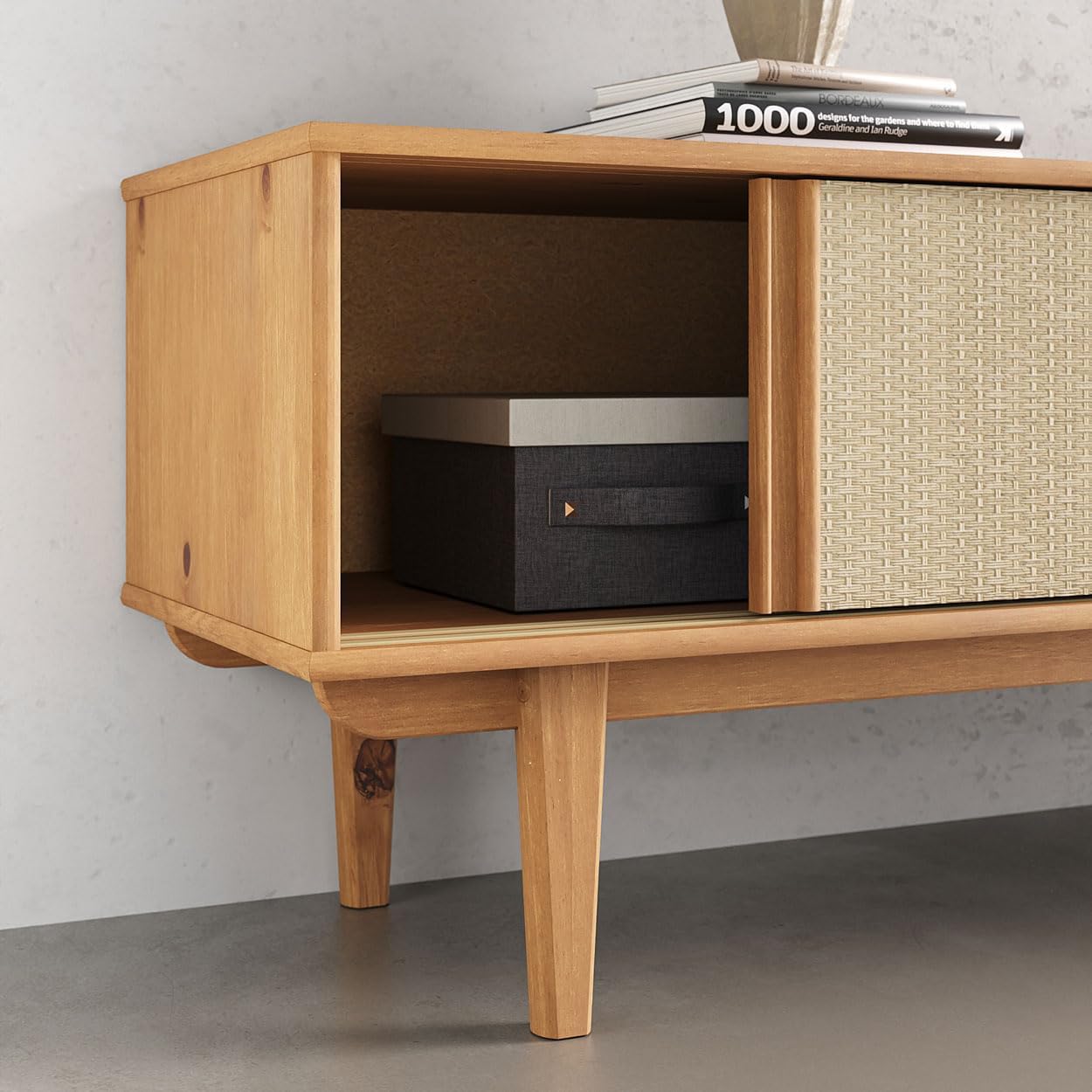 Close-up of the open compartment of the IDIMEX Simona TV Room Rack