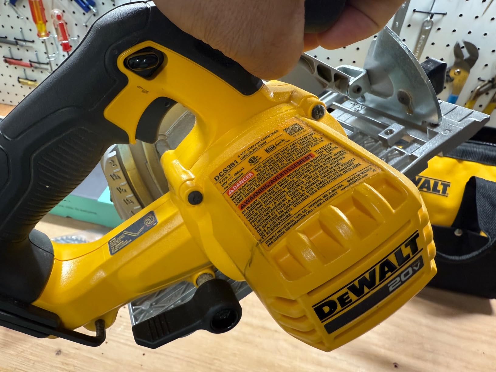 Close up of a DeWalt circular saw blade guard and bevel adjustment lever