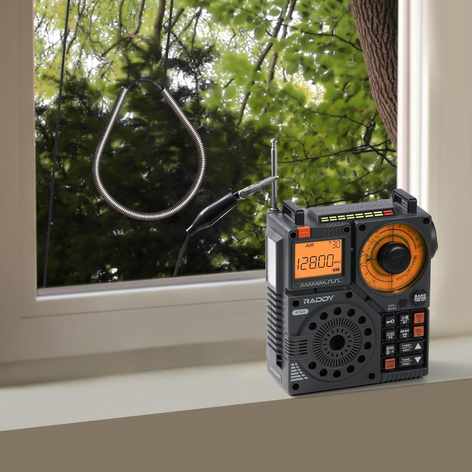 Raddy SW001 antenna connected to a Raddy RF320 radio placed near a window