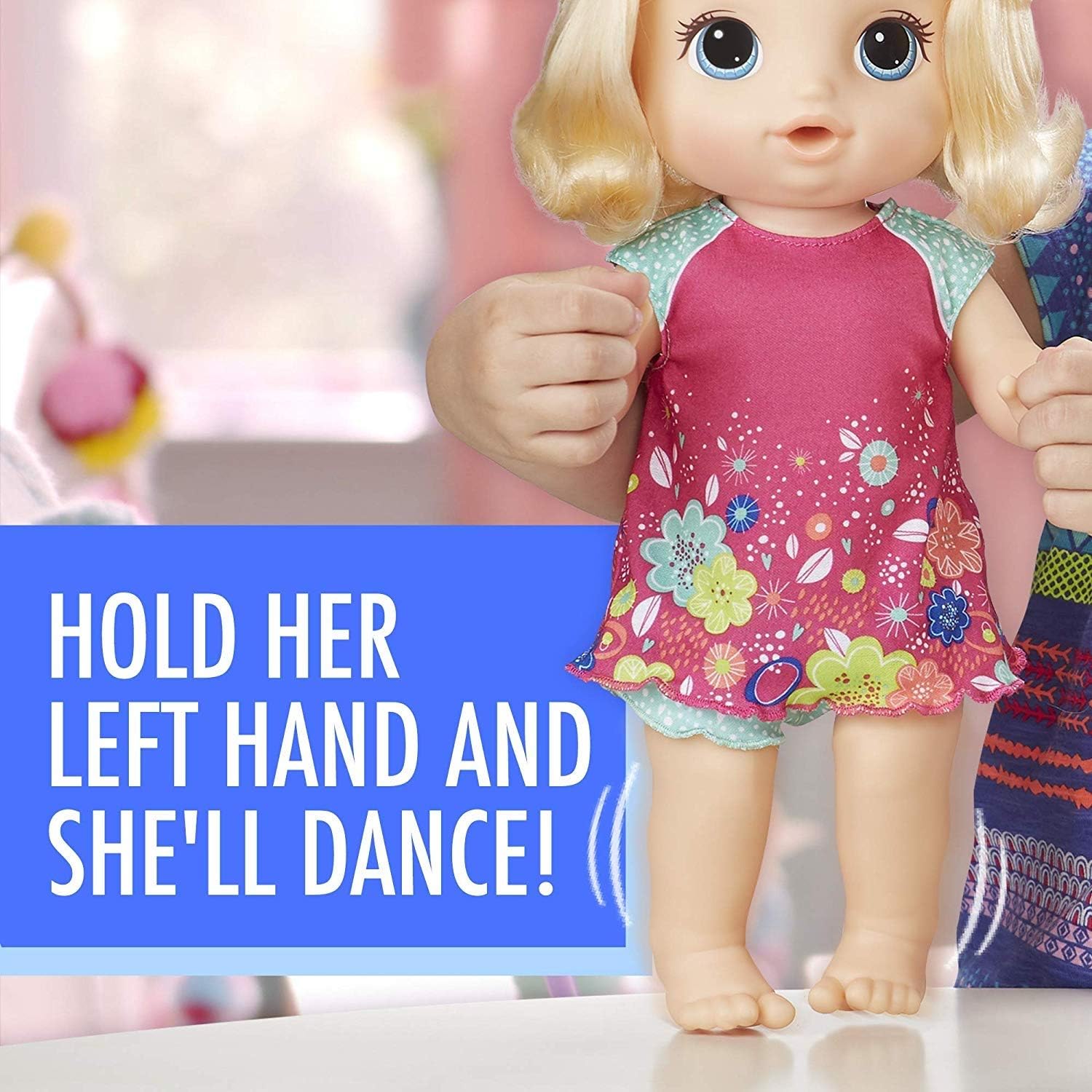 Child holding Baby Alive Potty Dance Baby doll's left hand to make her dance