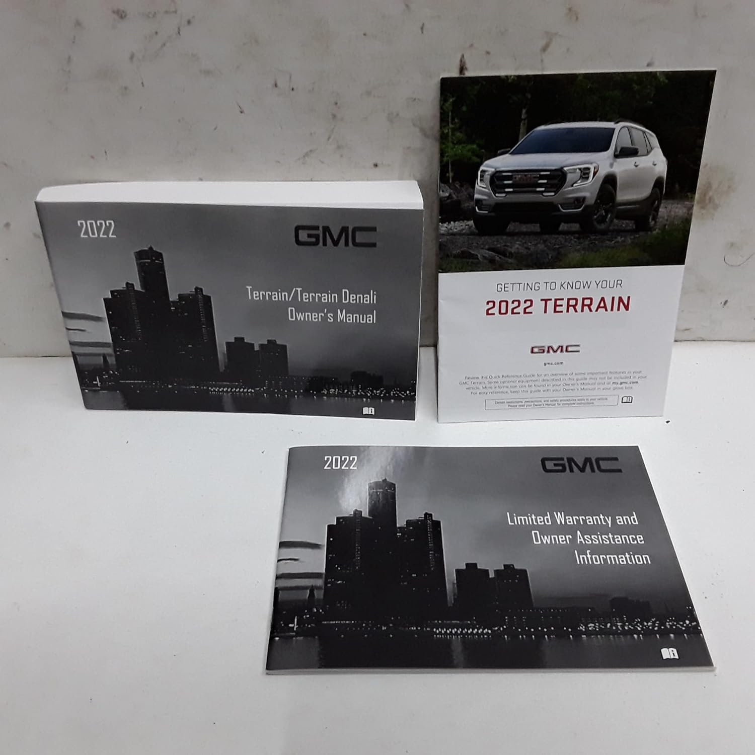 Image showing the 2022 GMC Terrain / Terrain Denali Owner's Manual, a Quick Reference Guide, and a Limited Warranty and Owner Assistance Information booklet.