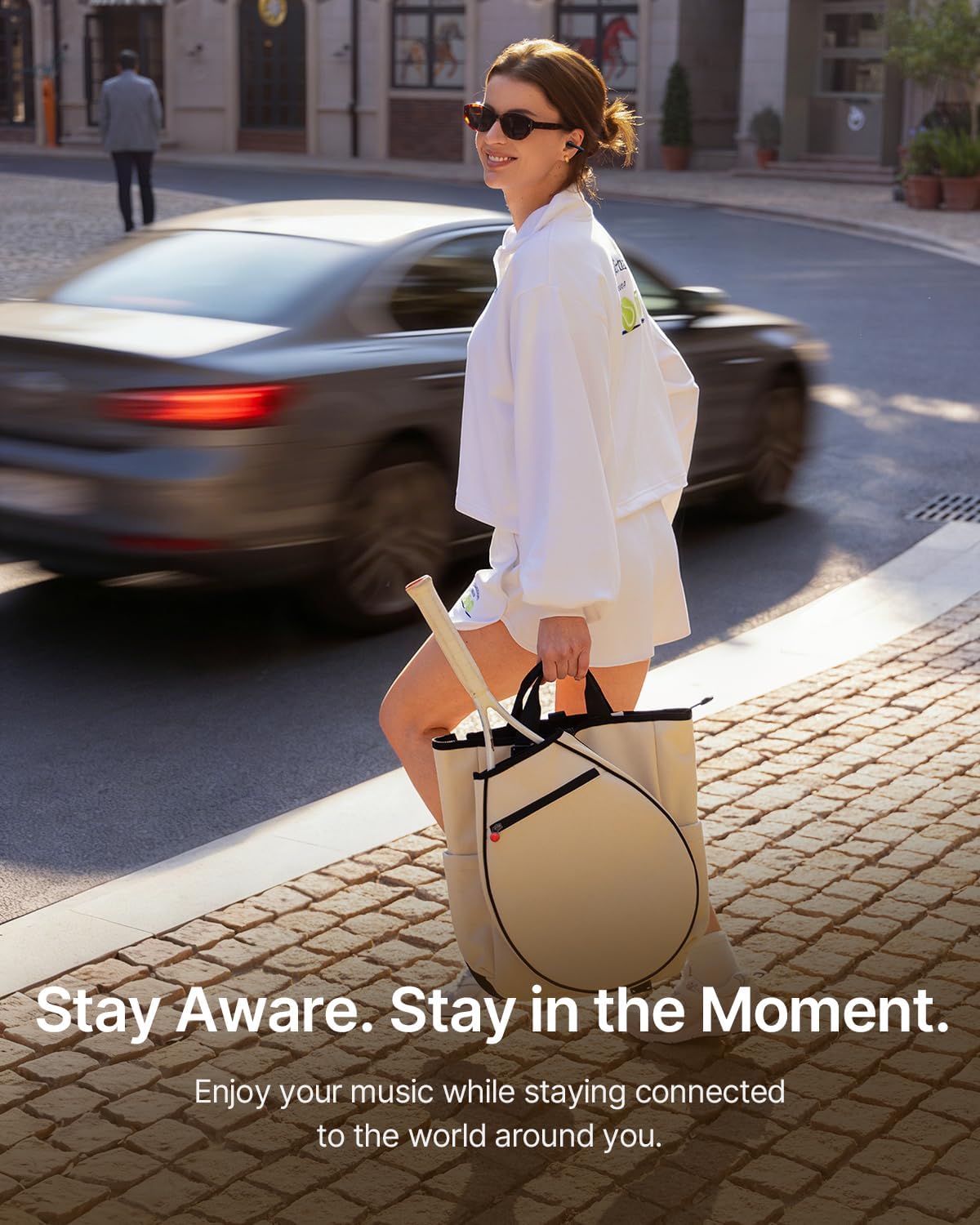 Woman walking outdoors with Baseus Bowie MC2 earbuds, aware of her surroundings