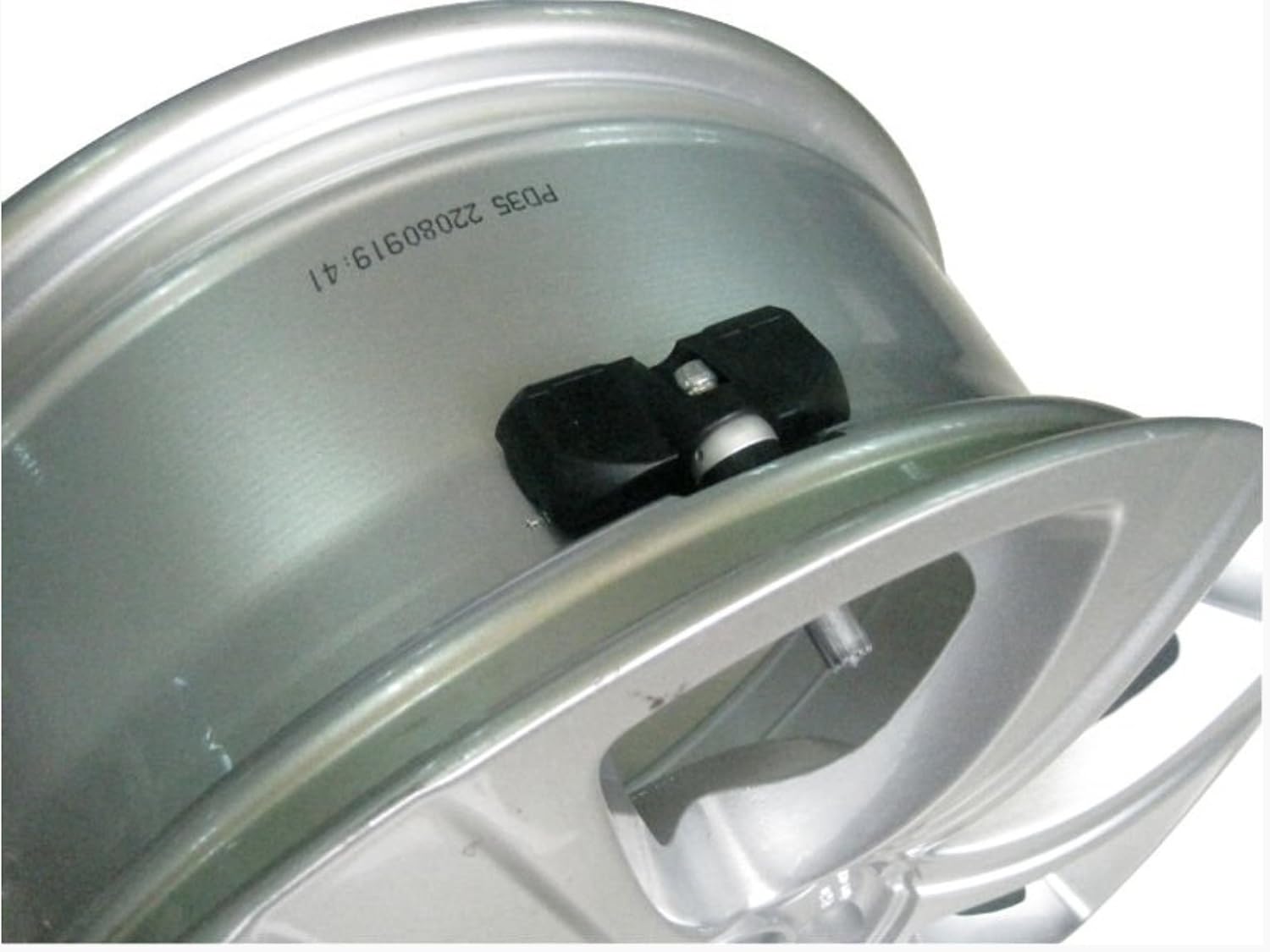 Close-up of an internal TPMS sensor mounted inside a wheel rim