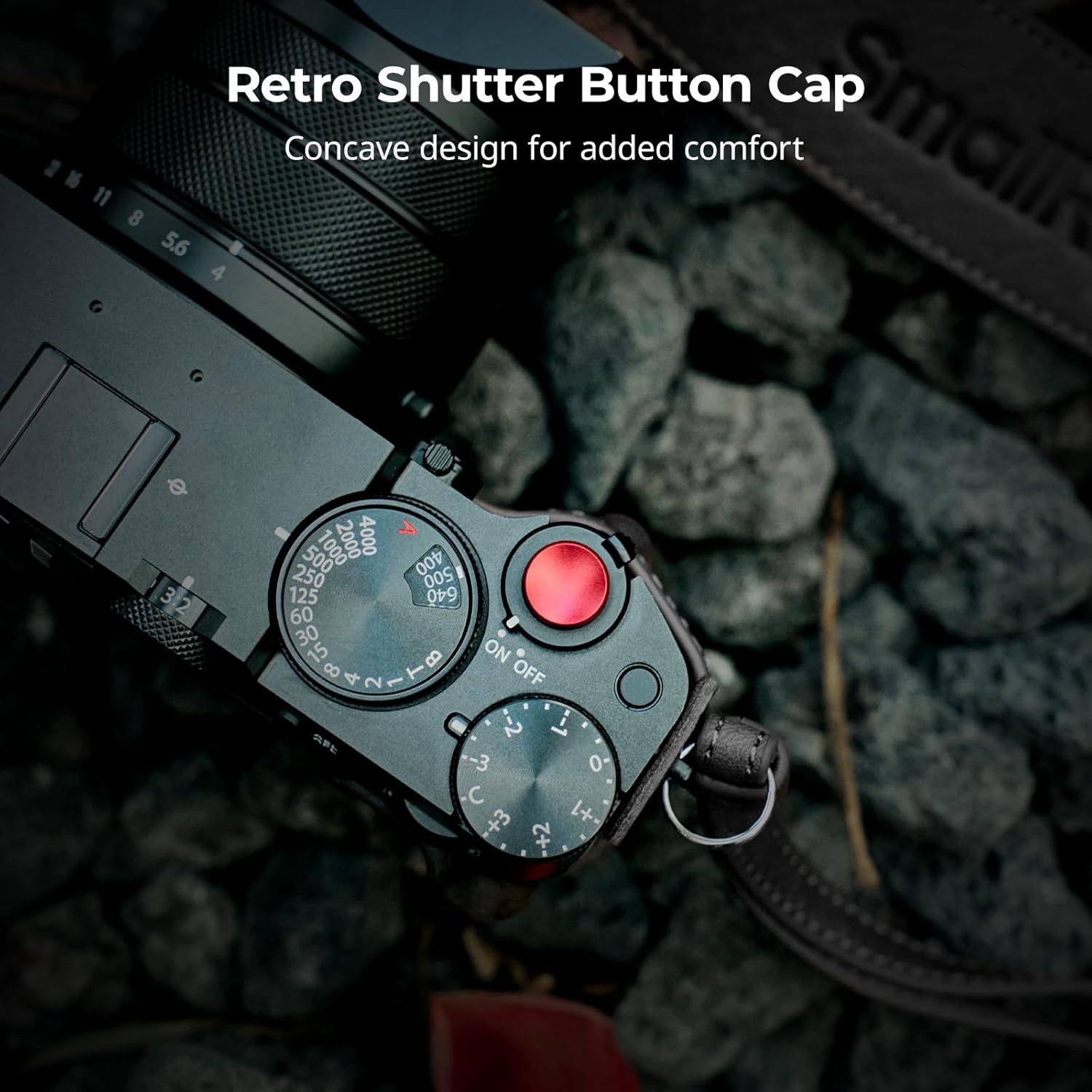 Avvicinamento view of a camera's top plate showing the red concave shutter button cap installed, enhancing the tactile feel.