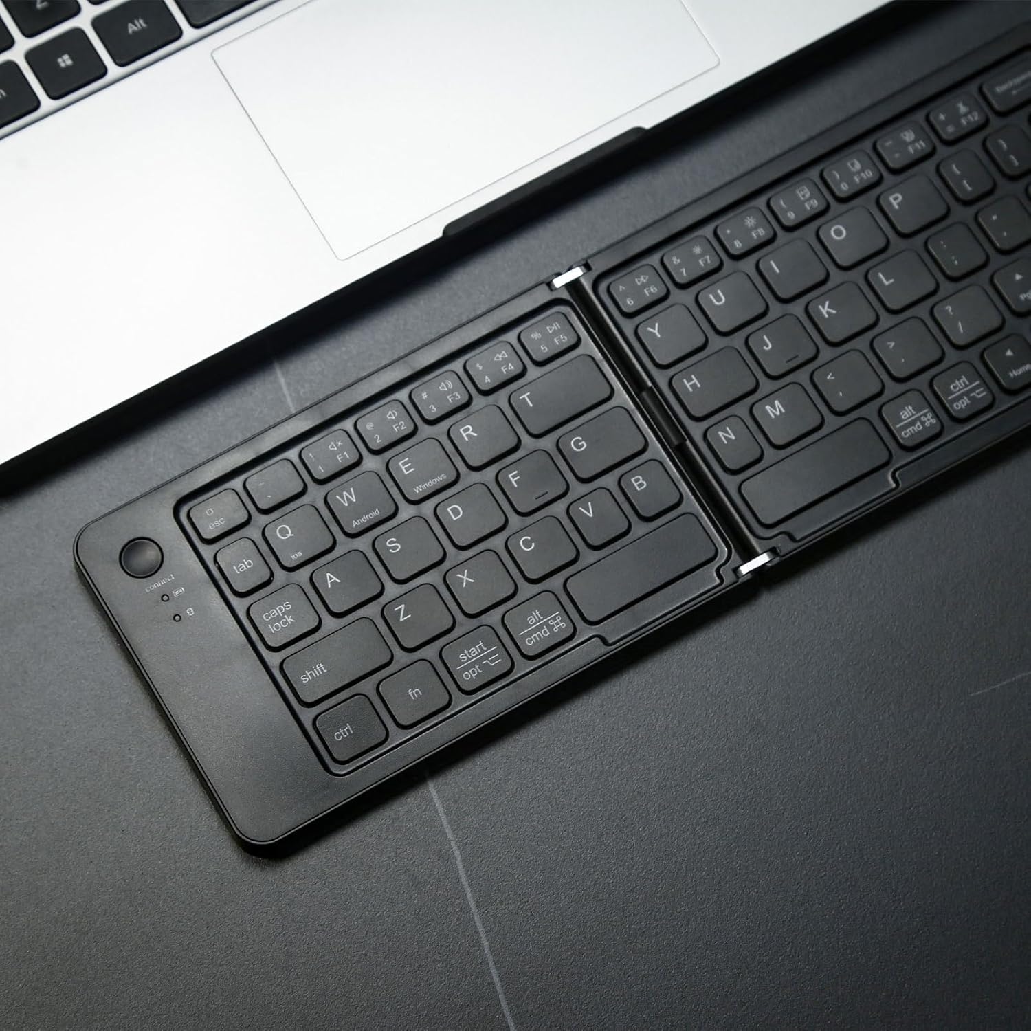 Unfolded MKETech Foldable Wireless Bluetooth Keyboard showing the full QWERTY layout.