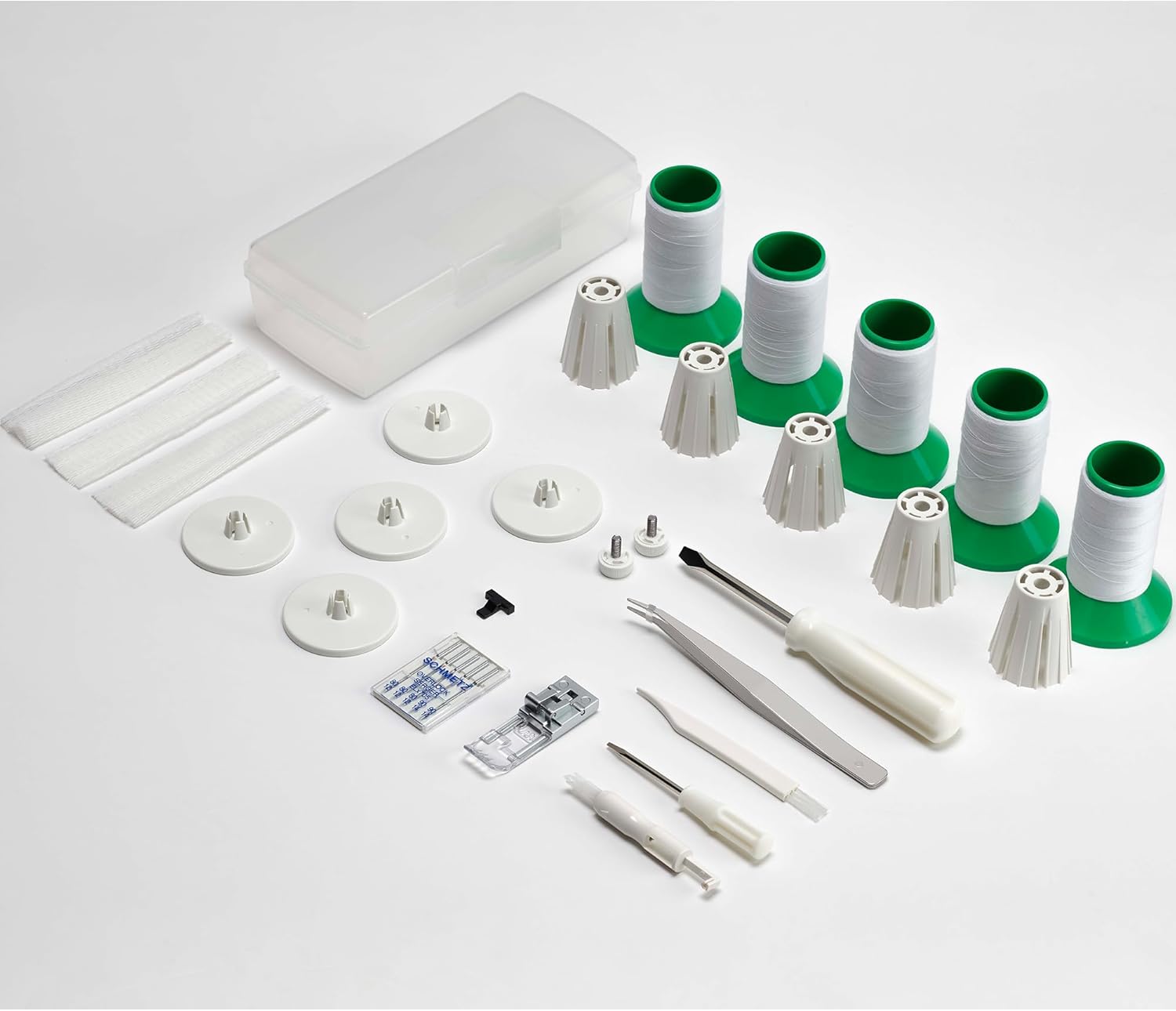 Included accessories for the Elna eXtend Covermax Coverstitch Serger, including tools and spools.