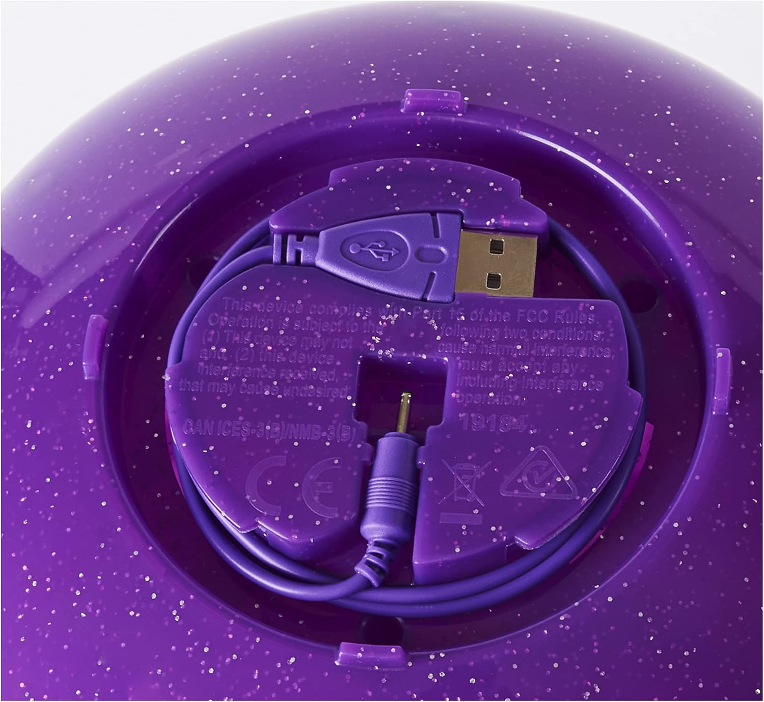 Close-up of the USB charging port and cable storage under the egg base