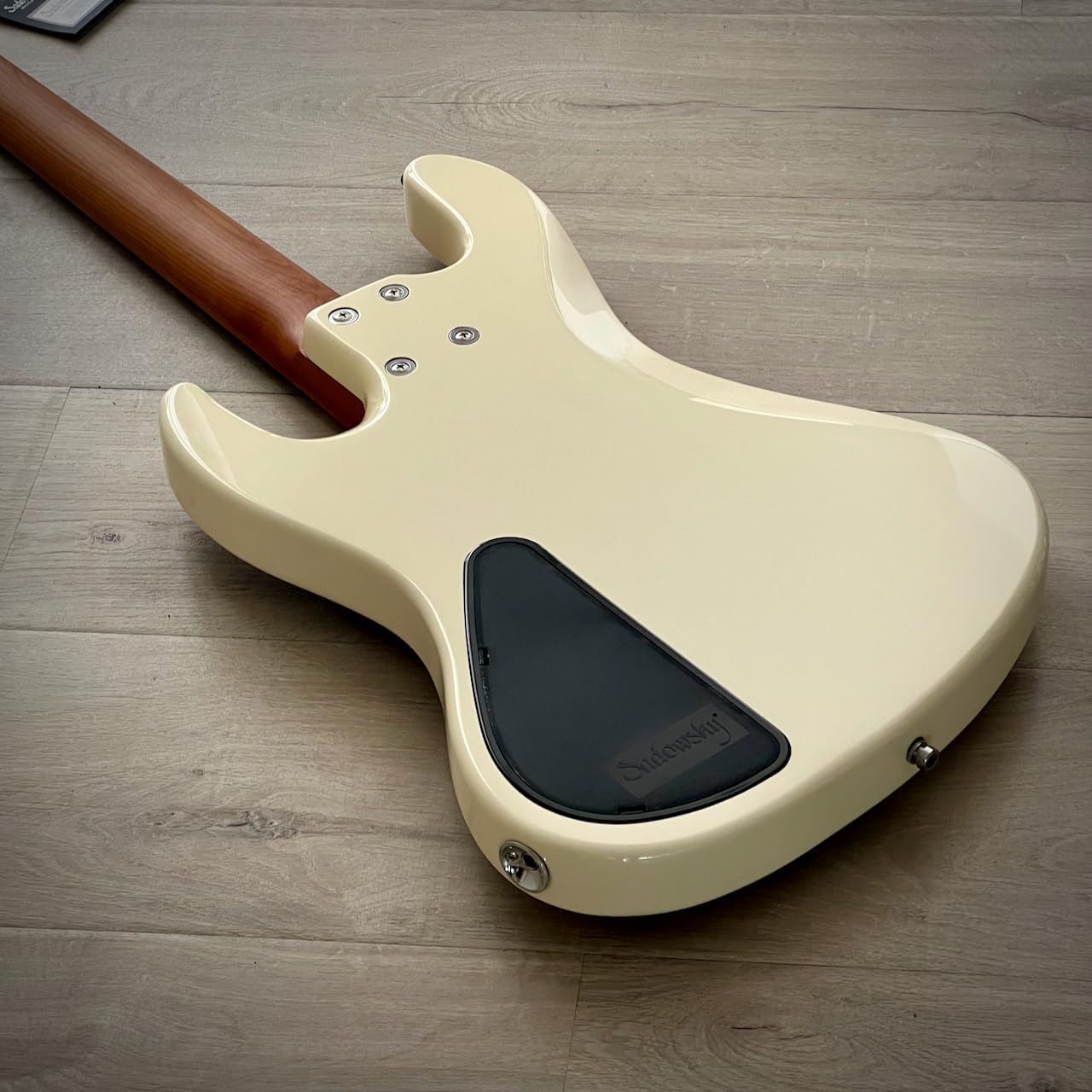 Close-up of the back of the Sadowsky MetroExpress bass, showing the control cavity cover