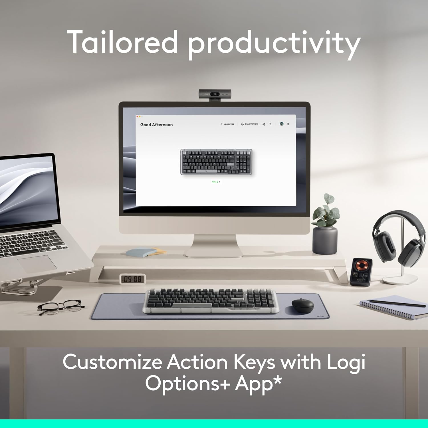 A desktop setup showing the Logitech Alto Keys K98M keyboard and a monitor displaying the Logi Options+ app interface for customization.