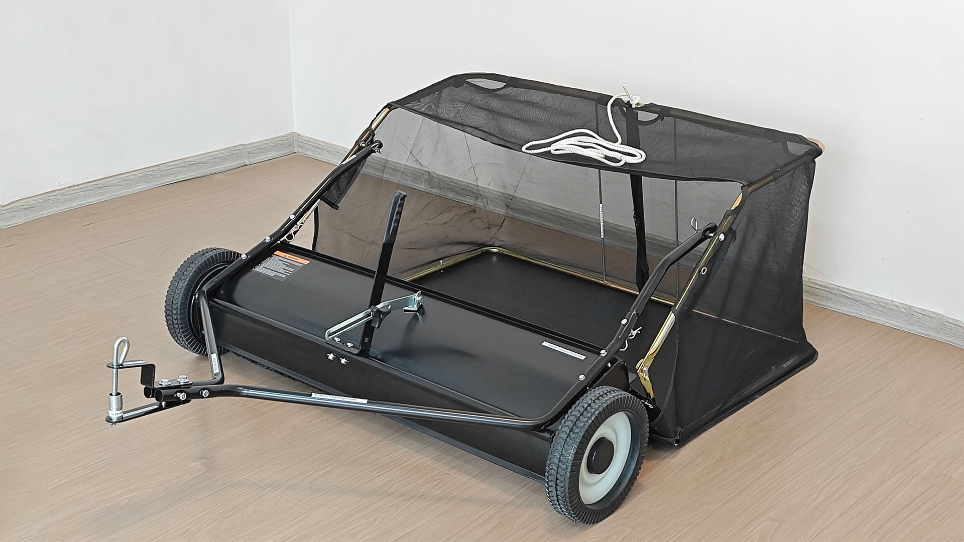What is a tow-behind lawn sweeper?