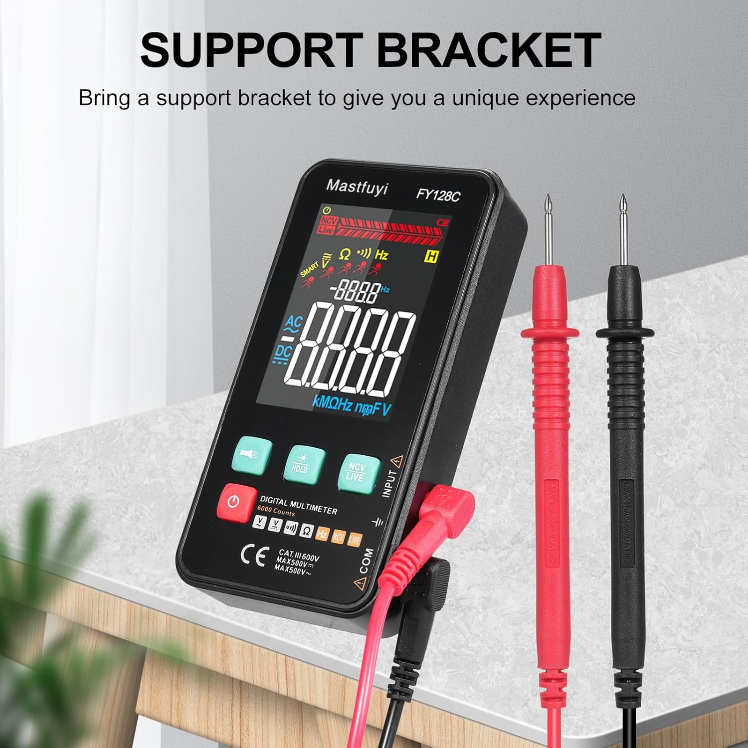 The FY128C Smart Digital Multimeter with its integrated support bracket extended, holding the device at an angle for better viewing, alongside red and black test leads.