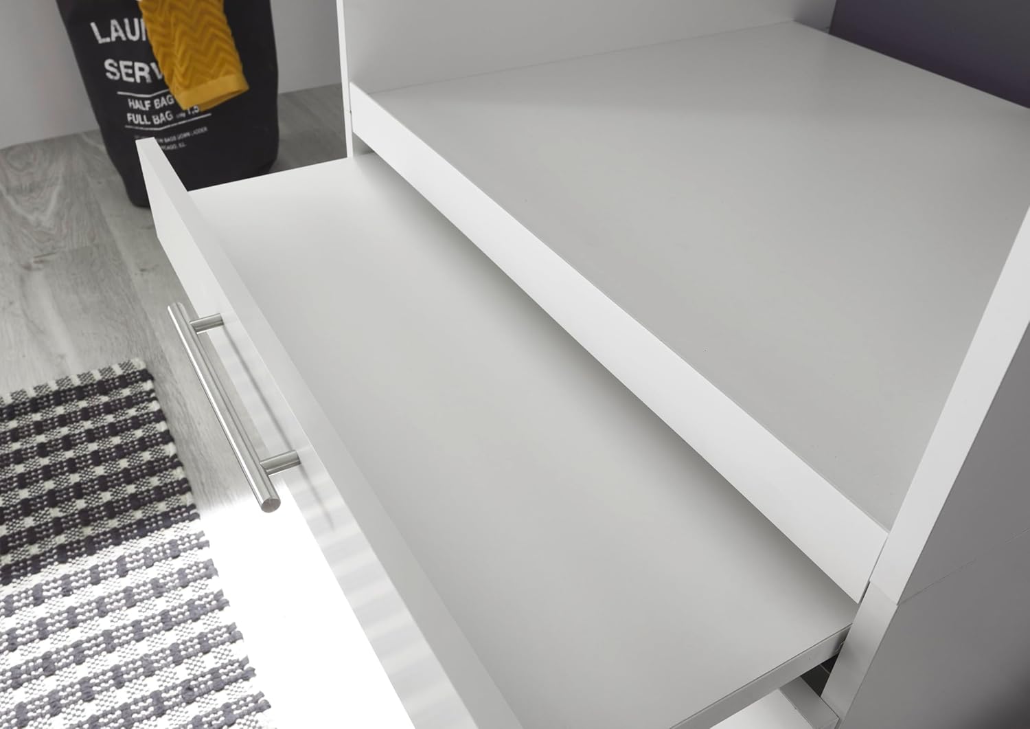 Close-up of the metal rail handles on the cabinet drawers