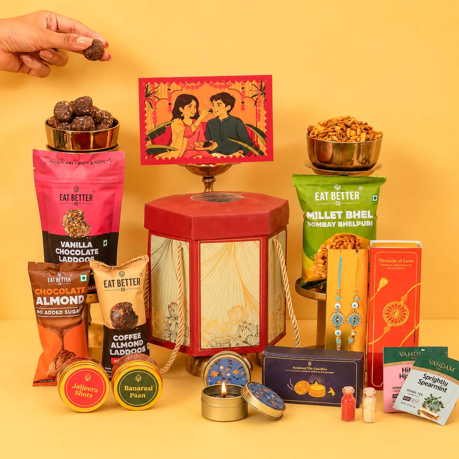 Pyaar Ka Pitara 14-Item Rakhi Gift Hamper for Brother and Bhabhi - Bhaiya Bhabhi Rakhi Set, Evil Eye & Lumba Rakhi, Roli-Chawal, Dry-Fruit Laddoos, Choco-Nuts, Candles, Mukhwas, Tea & more