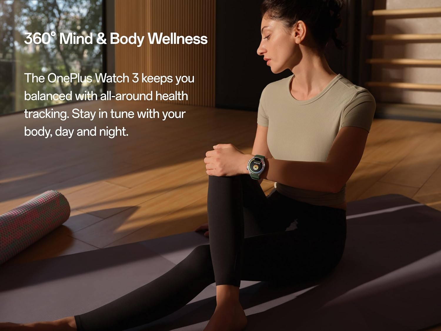 A person sitting on a yoga mat, looking at their OnePlus Watch 3, with text '360° Mind & Body Wellness'