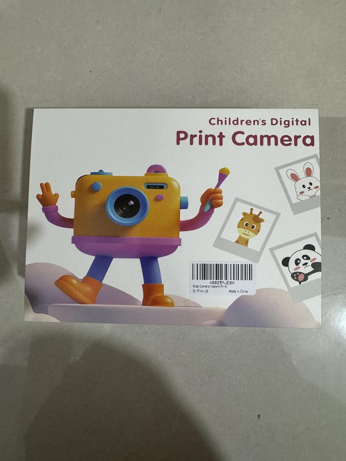 A pink MISIRUN Instant Print Kids Digital Camera showing the layout of buttons and ports, including the front camera, power button, shutter button, back button, print button, left/right buttons, view file button, setting button, rear camera, Type-C port, 32g TF card slot, and reset button.