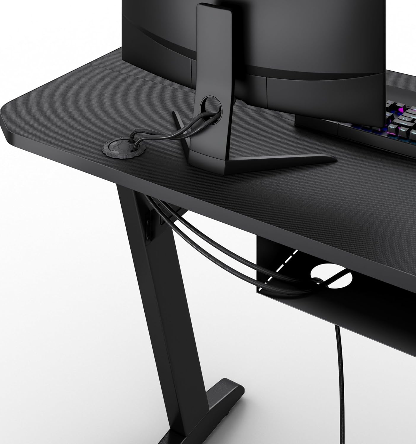 Close-up of the cable management grommets on the SENSE7 Nomad Basic Gaming Desk